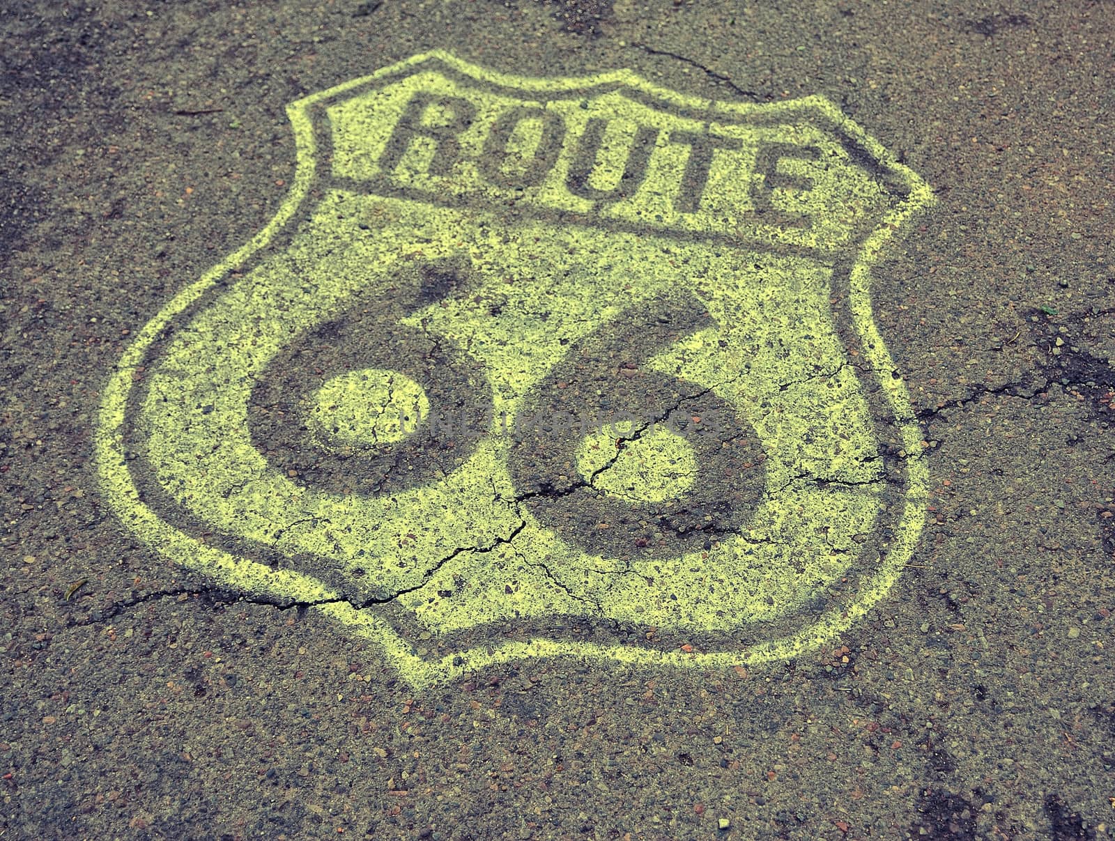 Historic U.S. old Route 66 sign on the asphalt.