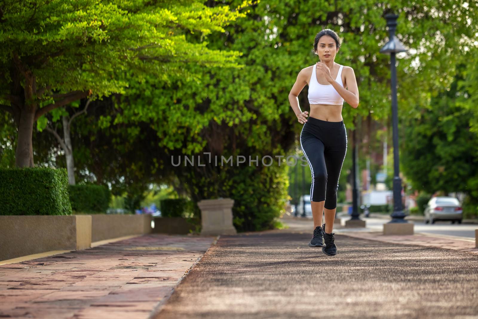 Beautiful woman jogger outdoor living healthy lifestyle in city park. Concept sport and a healthy lifestyle in the city
