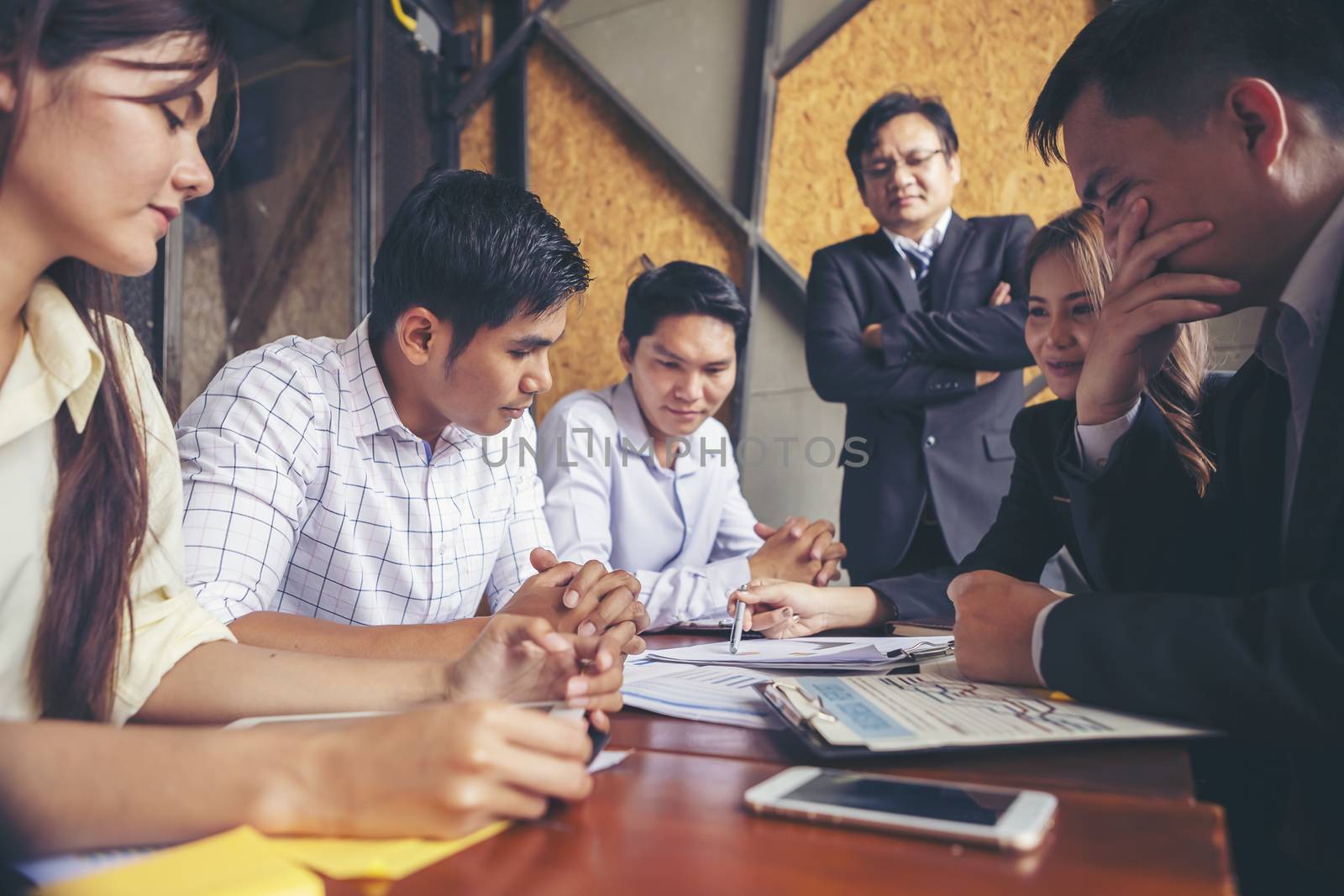 Group of young businessmen are meeting and presenting a plan for by numberone9018