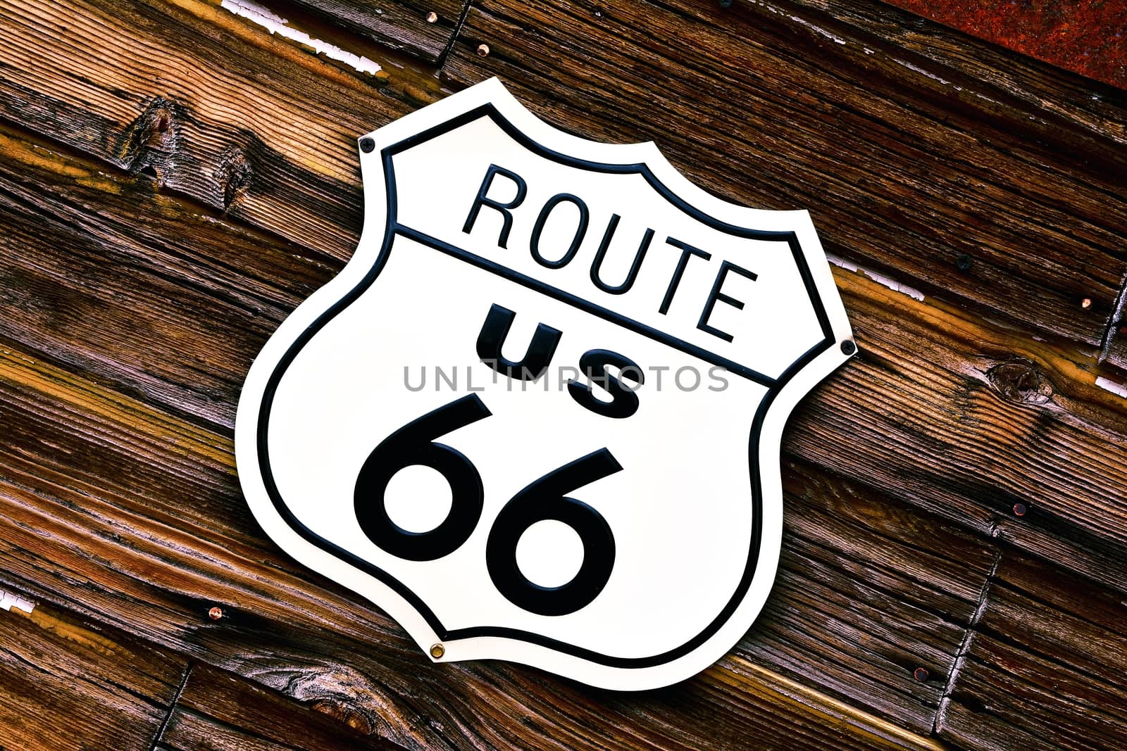 Historic U.S. old Route 66 sign with wooden background.