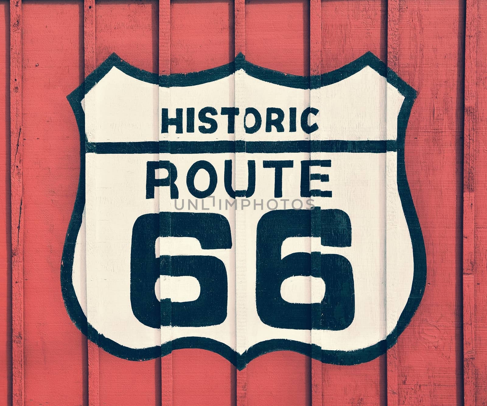 Historic U.S. old Route 66 sign with wooden background.
