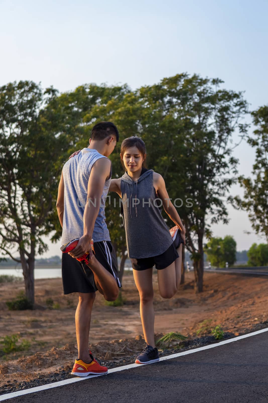 Running at sunrise couple exercising for marathon and workout 
fitness, sport, people and lifestyle concept - Happy couples exercising with outdoor running