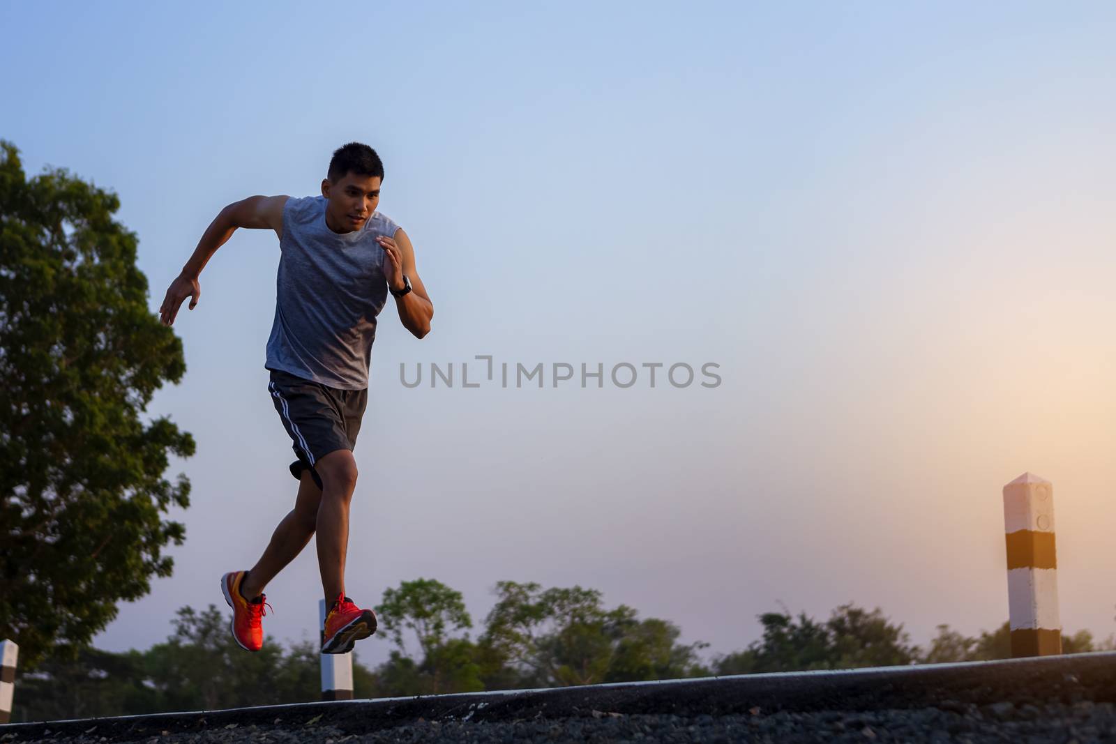 young man runner running on road. healthy lifestyle young fitnes by numberone9018