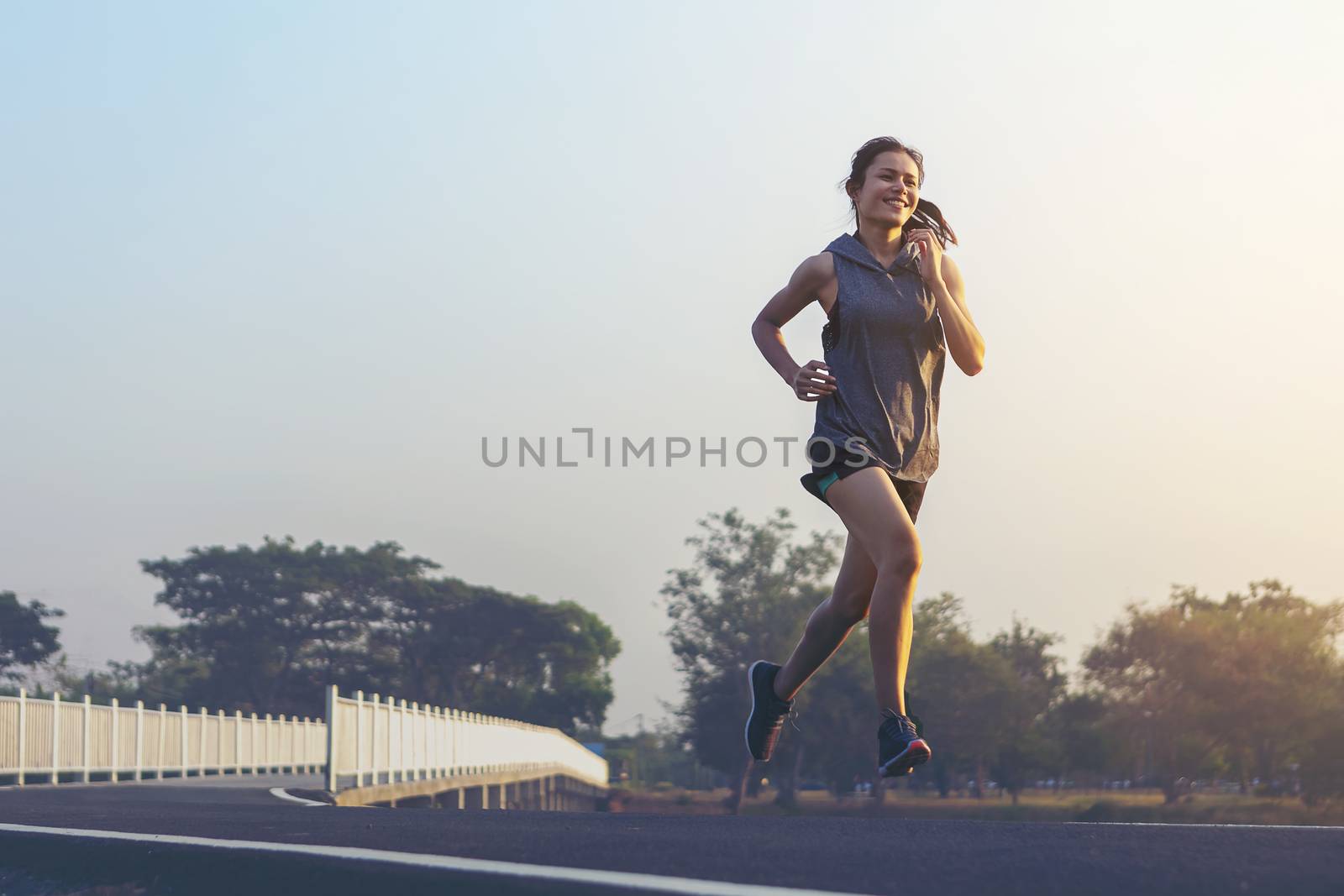 young woman runner running on road. healthy lifestyle young fitness woman running