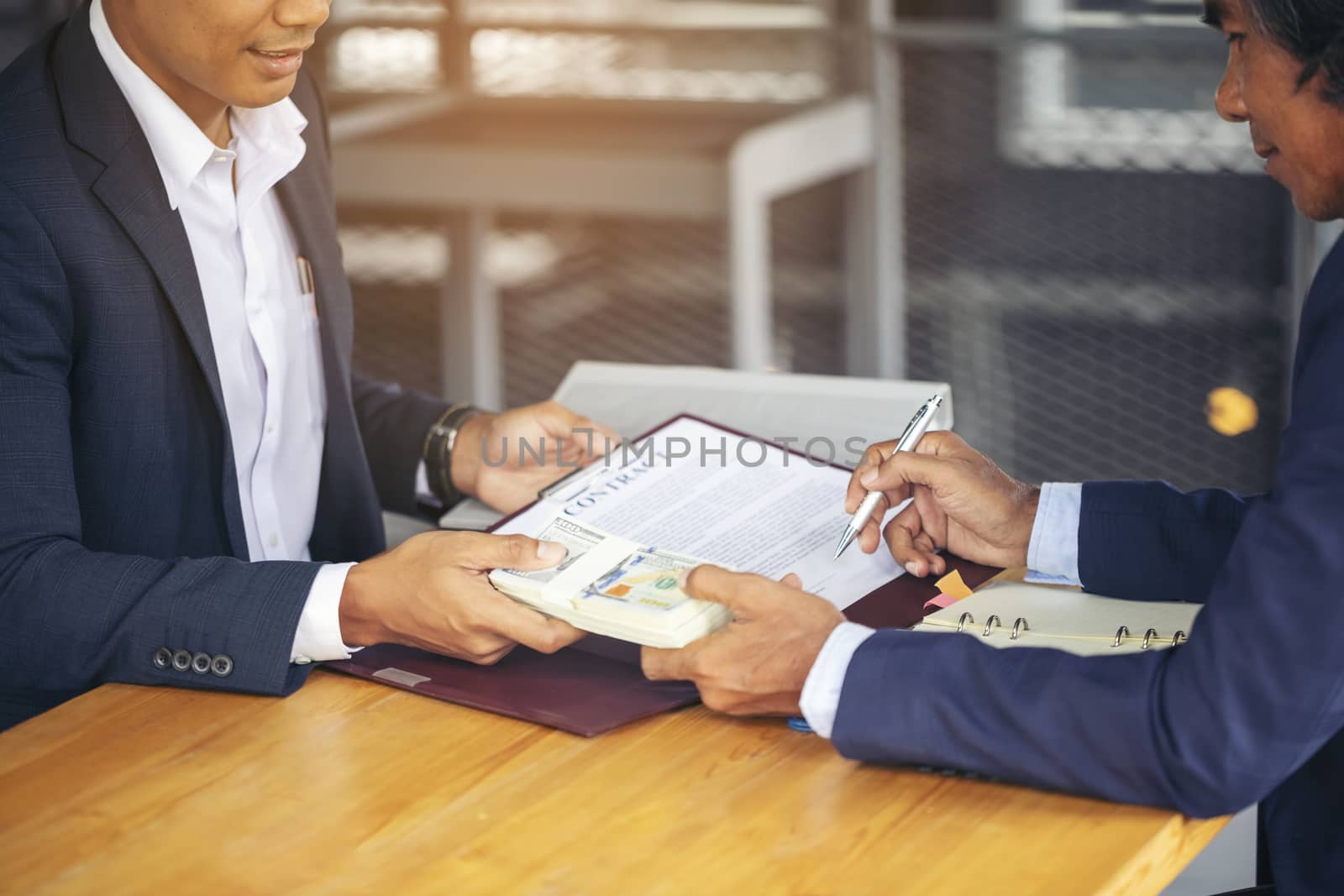 Image of business people hands working with papers at meeting. Businessman holding pens and holding graph paper are meeting to plan sales to meet targets set in next year.