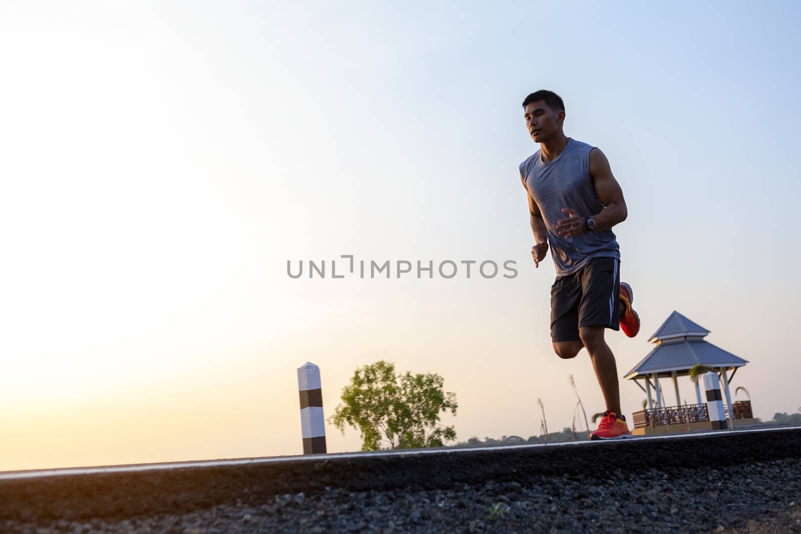 young man runner running on road. healthy lifestyle young fitnes by numberone9018