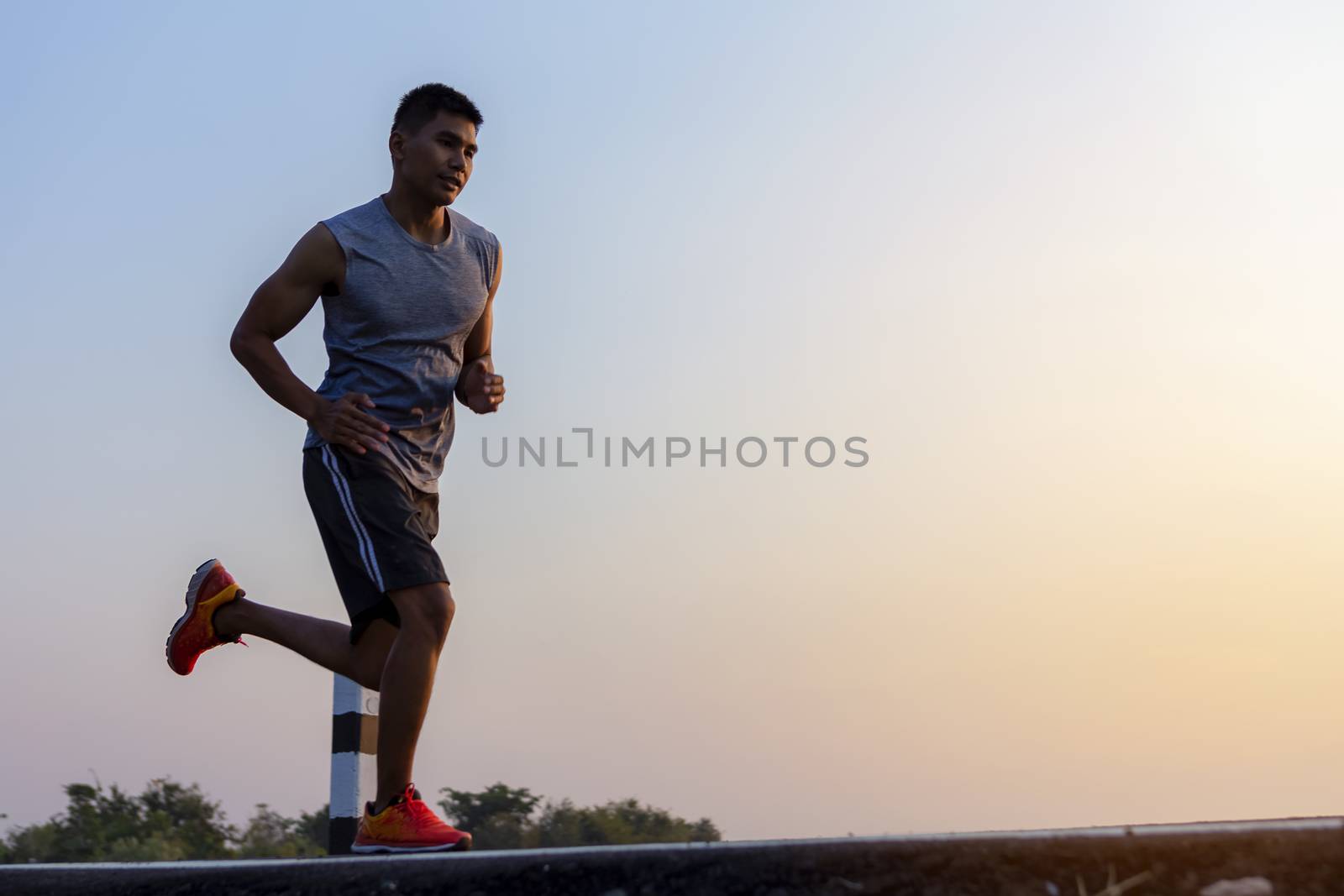 young man runner running on road. healthy lifestyle young fitness man running
