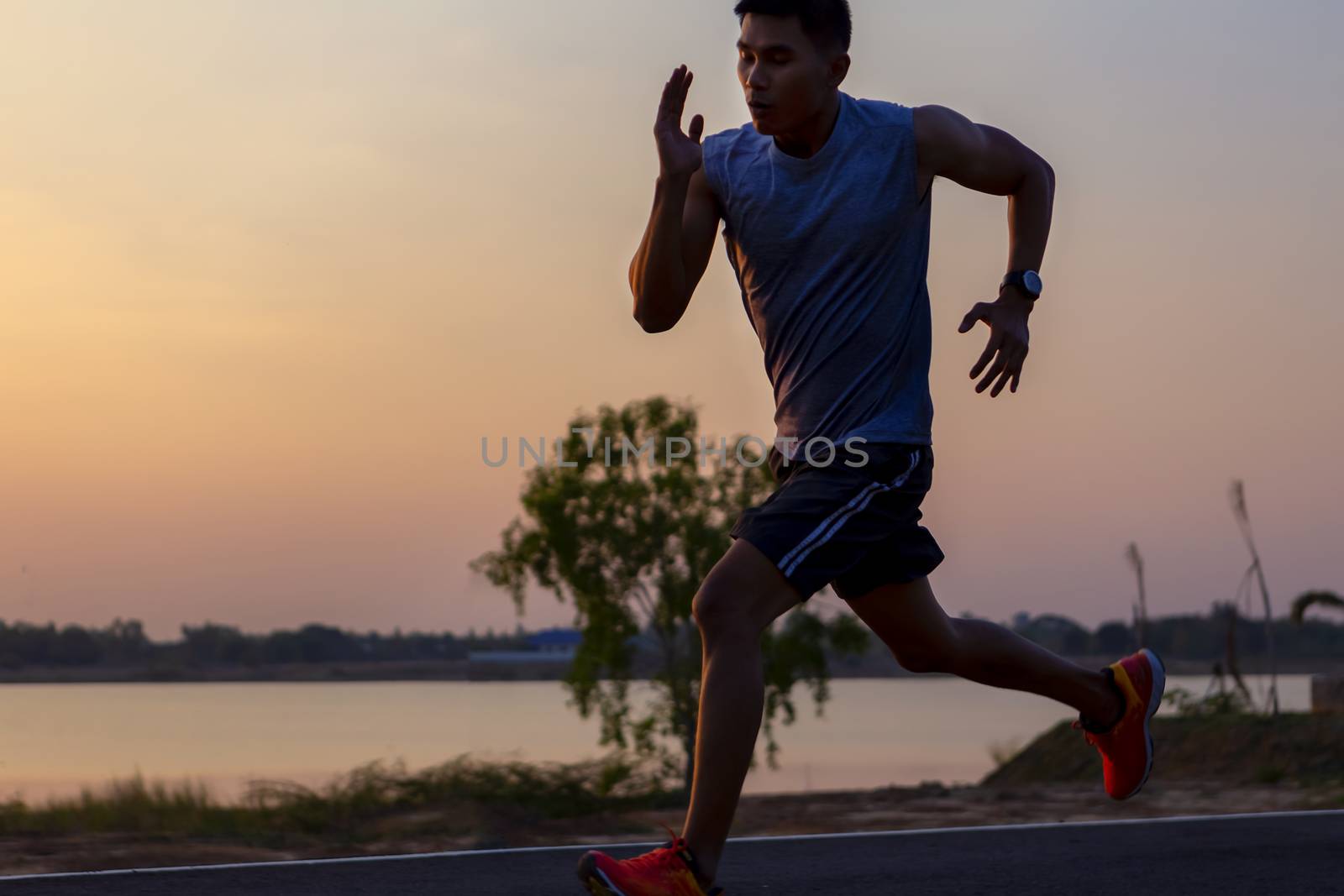 young man runner running on road. healthy lifestyle young fitness man running
