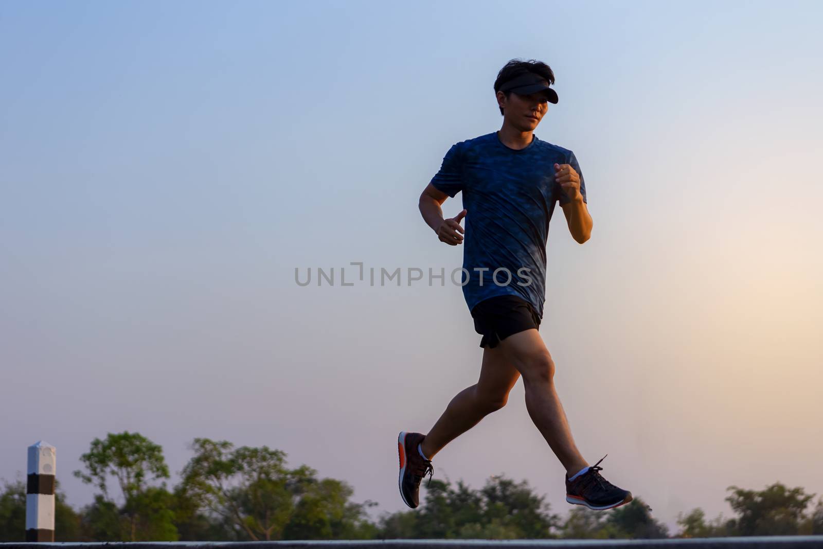 young man runner running on road. healthy lifestyle young fitness man running
