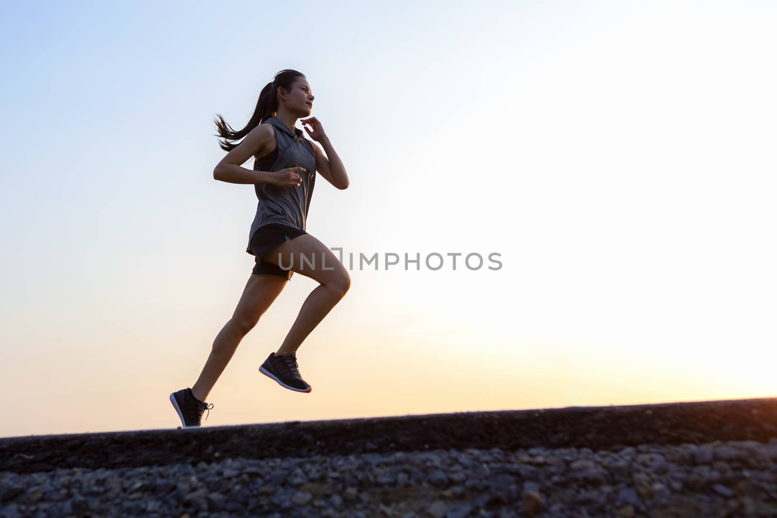 young woman runner running on road. healthy lifestyle young fitness woman running