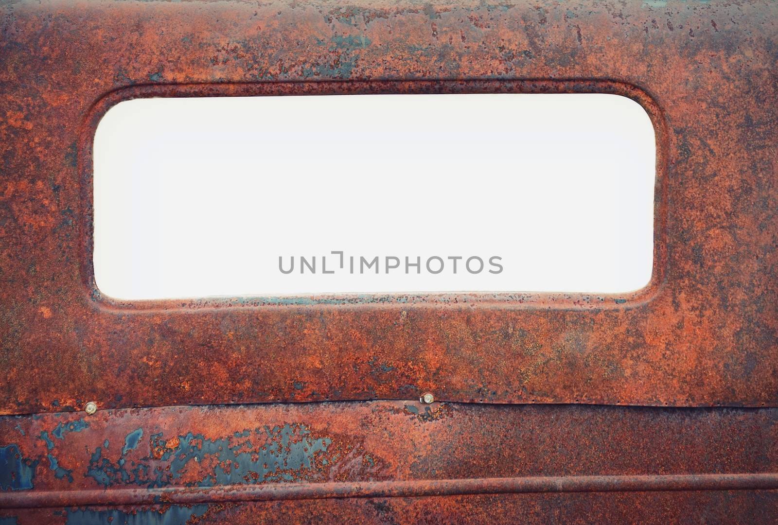 Old rusty car with blank window for copy space.