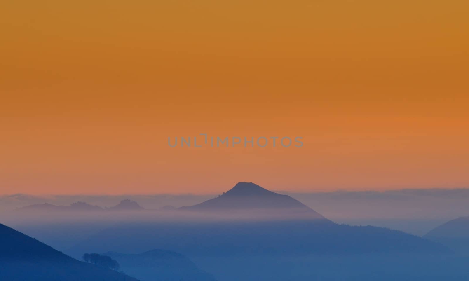 Hill in a fog on a sunrise. by CreativePhotoSpain