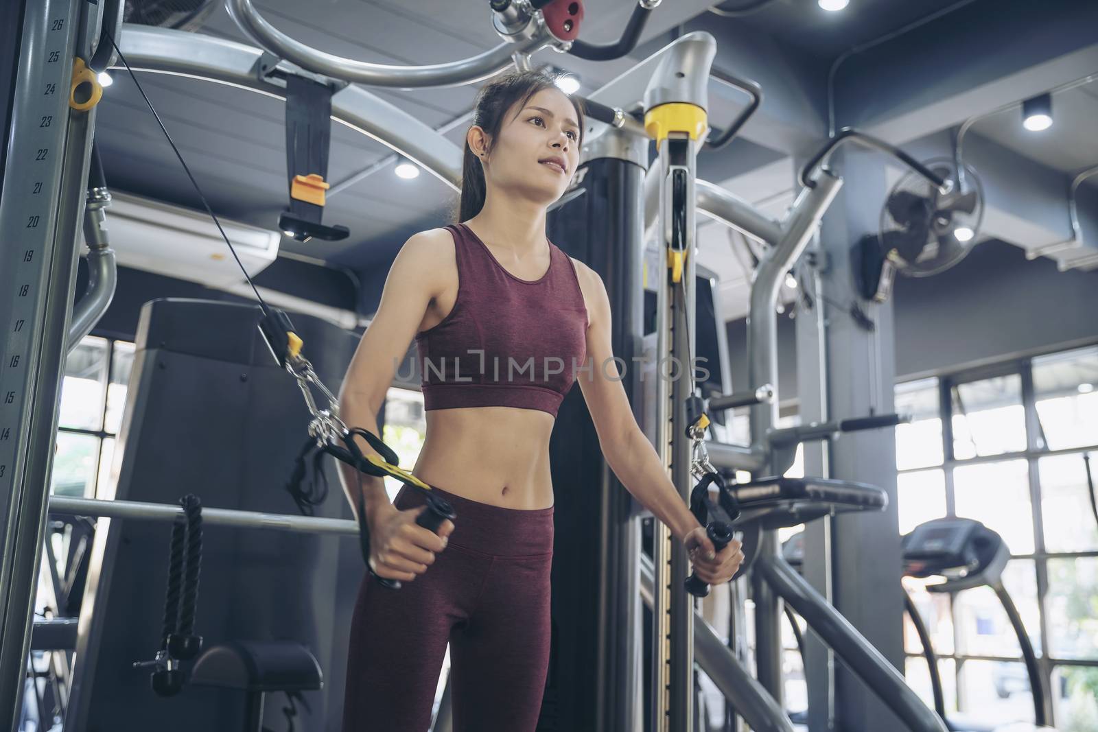 Young sporty man and woman training in modern gym. Gym exercise and workout concept