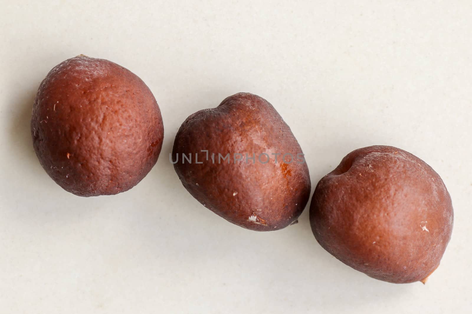 Snake fruit seeds on a white background. Close up of seeds. Salak is a fruit which in Indonesia has almost the same fruit skin as snake skin. The taste of the fruit is delicious.