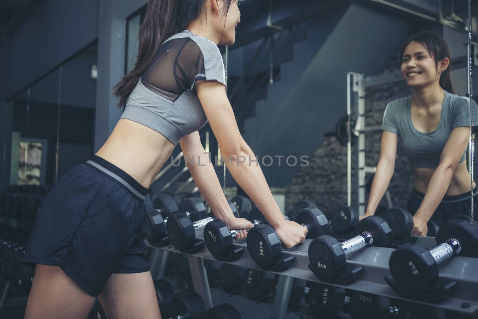Young sporty man and woman training in modern gym. Gym exercise  by numberone9018