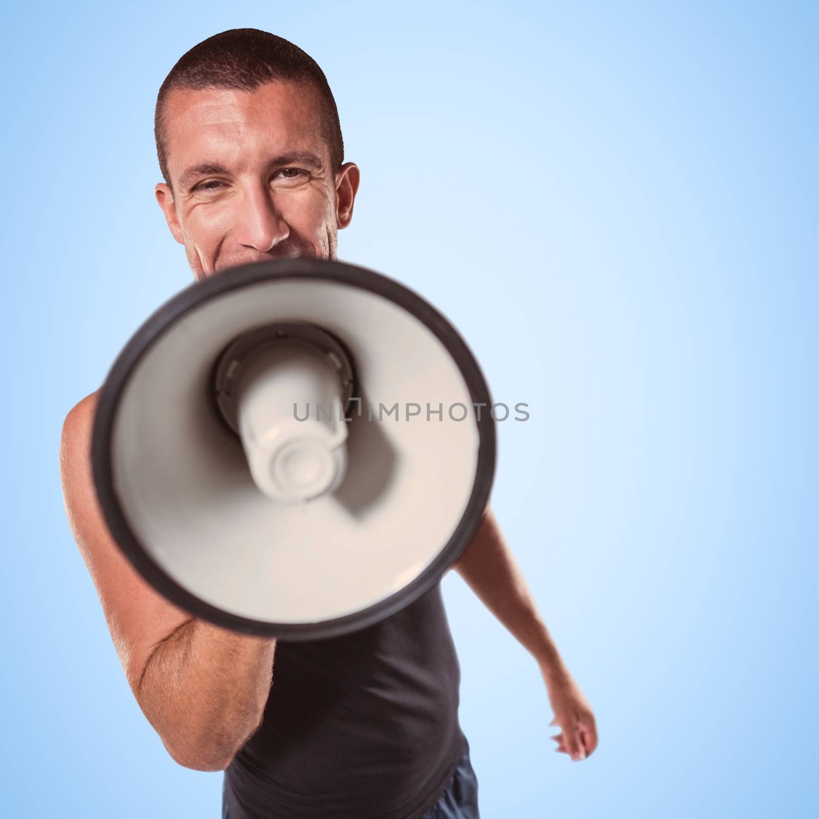 Male trainer yelling through megaphone against blue background