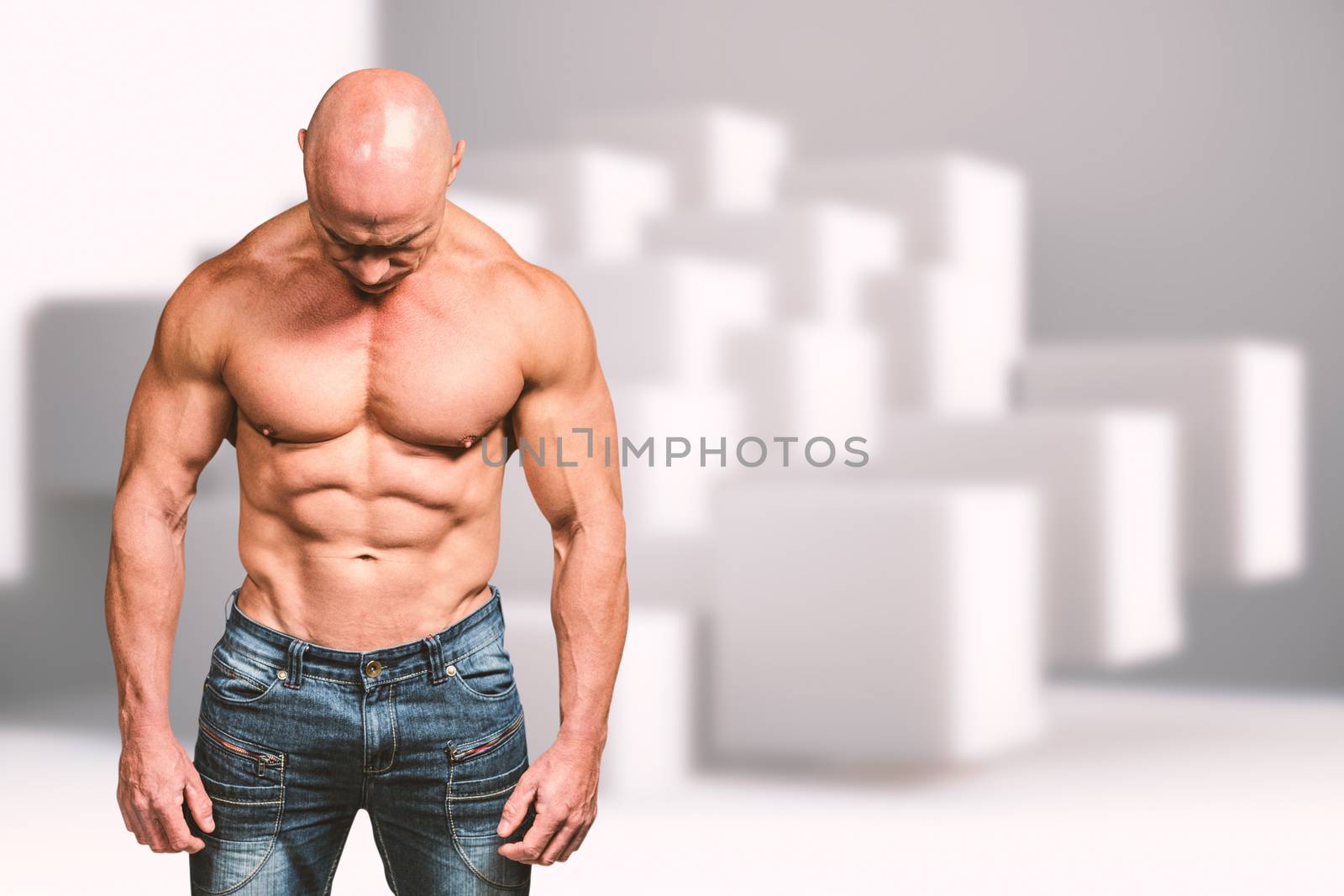 Muscular sad man looking down against abstract background