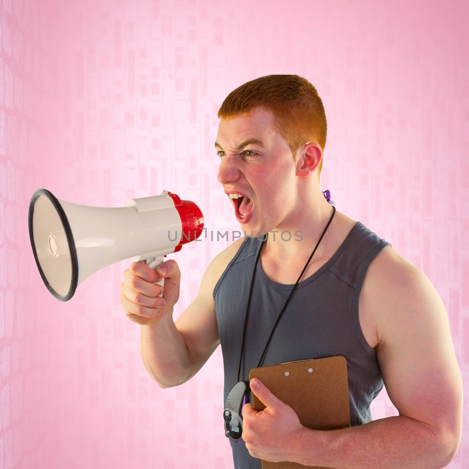 Angry personal trainer yelling through megaphone  against pink background