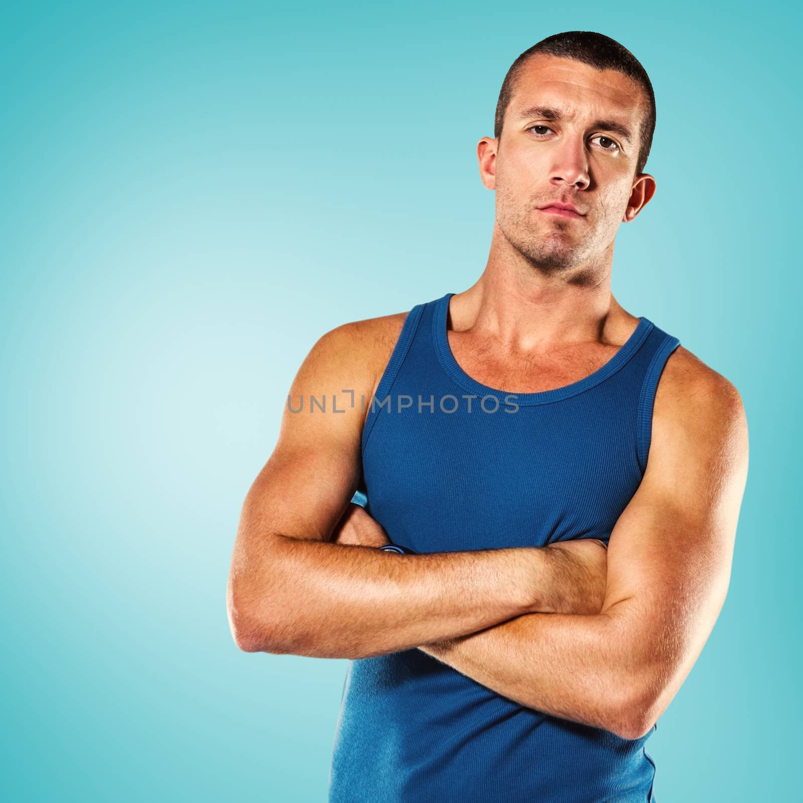 Serious athlete with arms crossed against blue vignette background