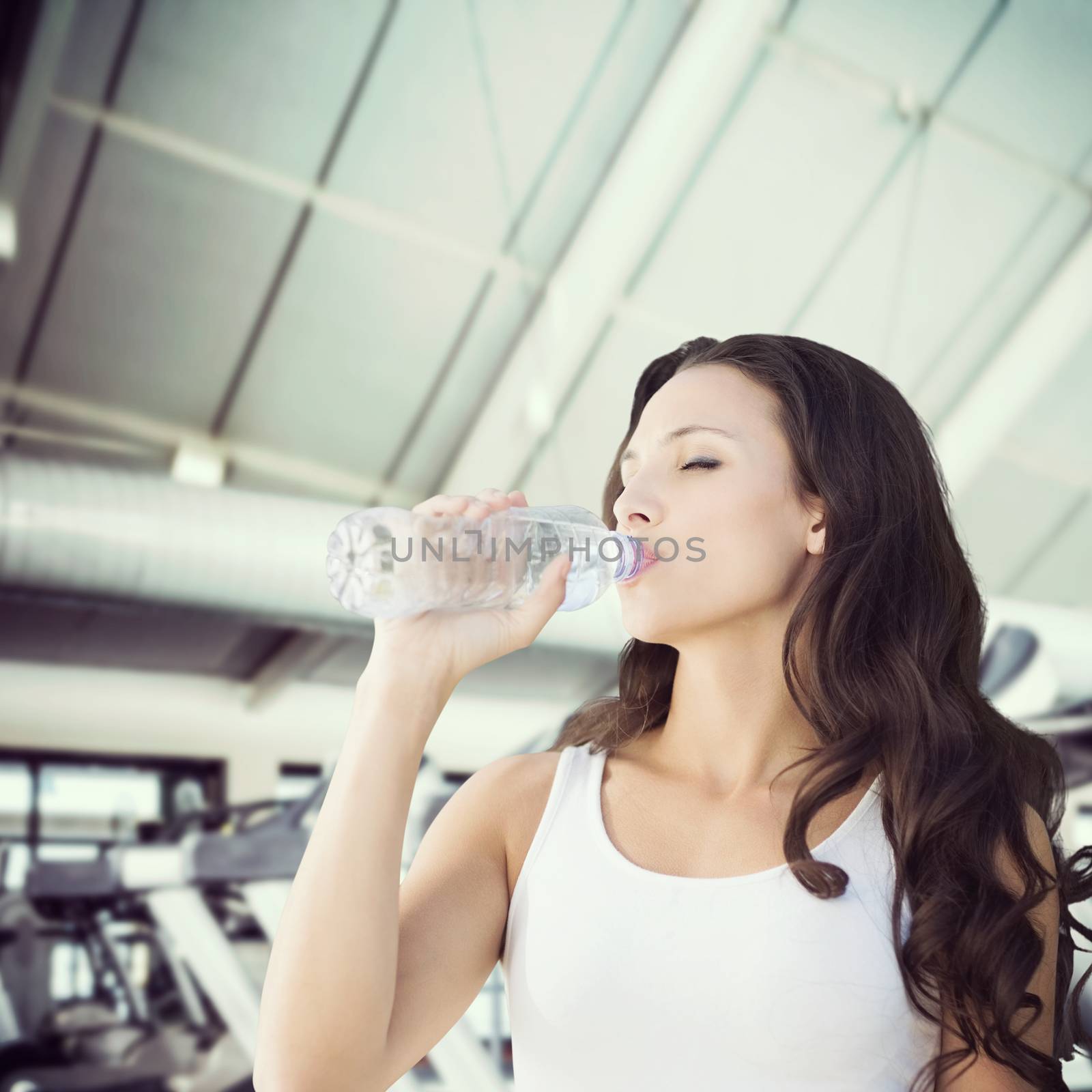 Composite image of brunette drinking water by Wavebreakmedia