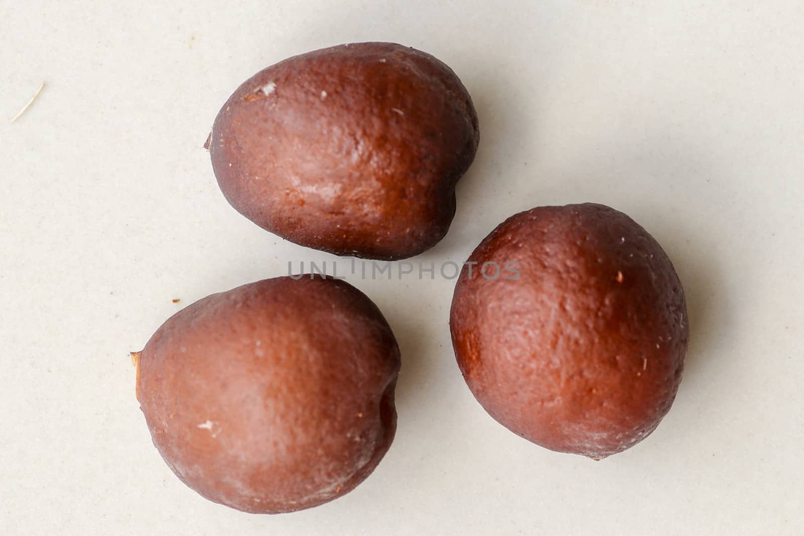 Snake fruit seeds on a white background. Close up of seeds. Salak is a fruit which in Indonesia has almost the same fruit skin as snake skin. The taste of the fruit is delicious.
