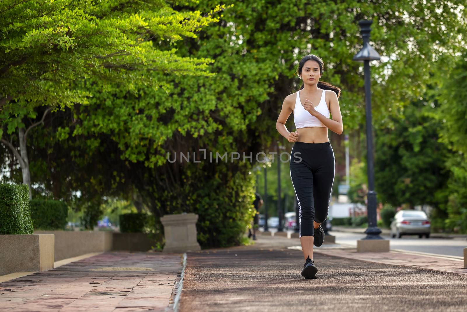 Beautiful woman jogger outdoor living healthy lifestyle in city park. Concept sport and a healthy lifestyle in the city
