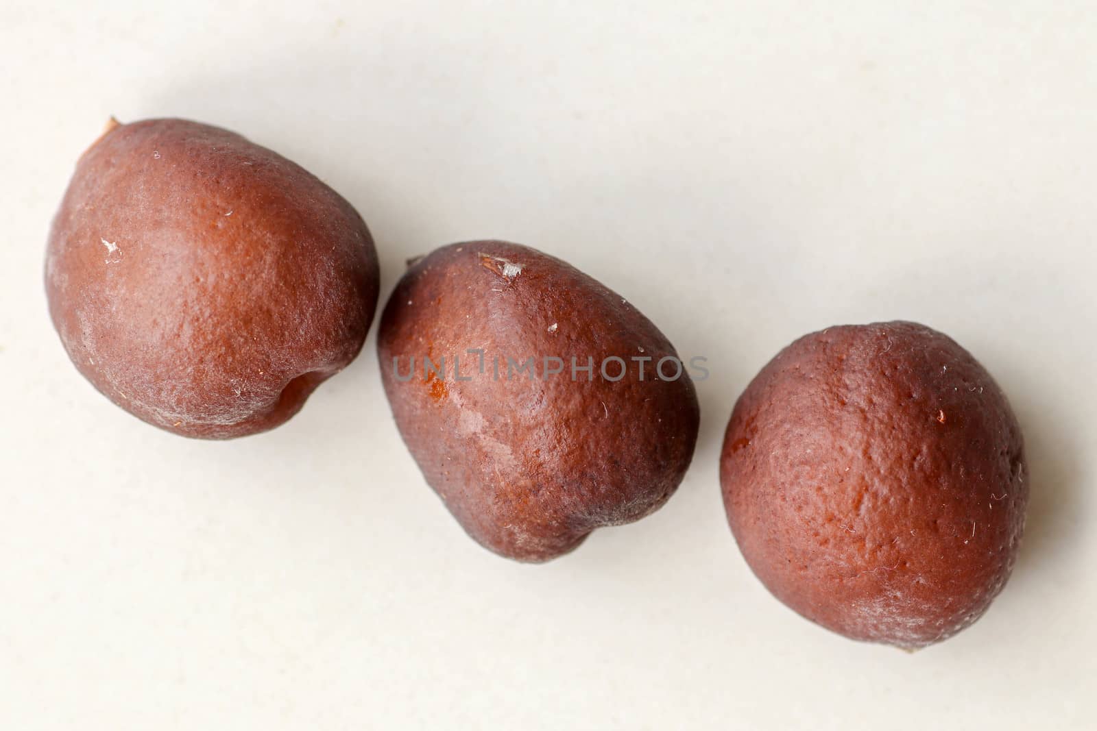 Snake fruit seeds on a white background. Close up of seeds. Salak is a fruit which in Indonesia has almost the same fruit skin as snake skin. The taste of the fruit is delicious.