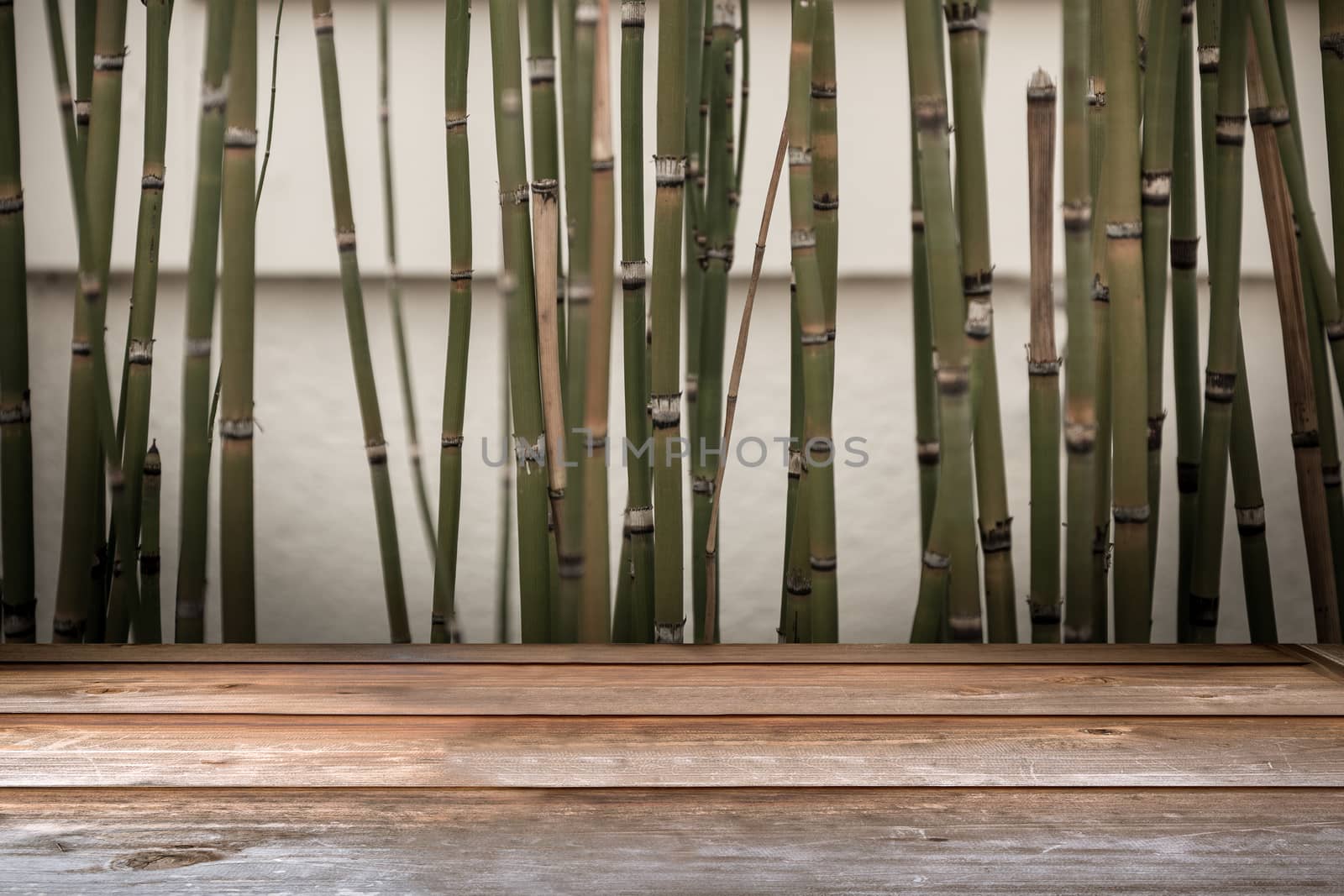 Wood tabletop in perspective view with bamboo vintage background