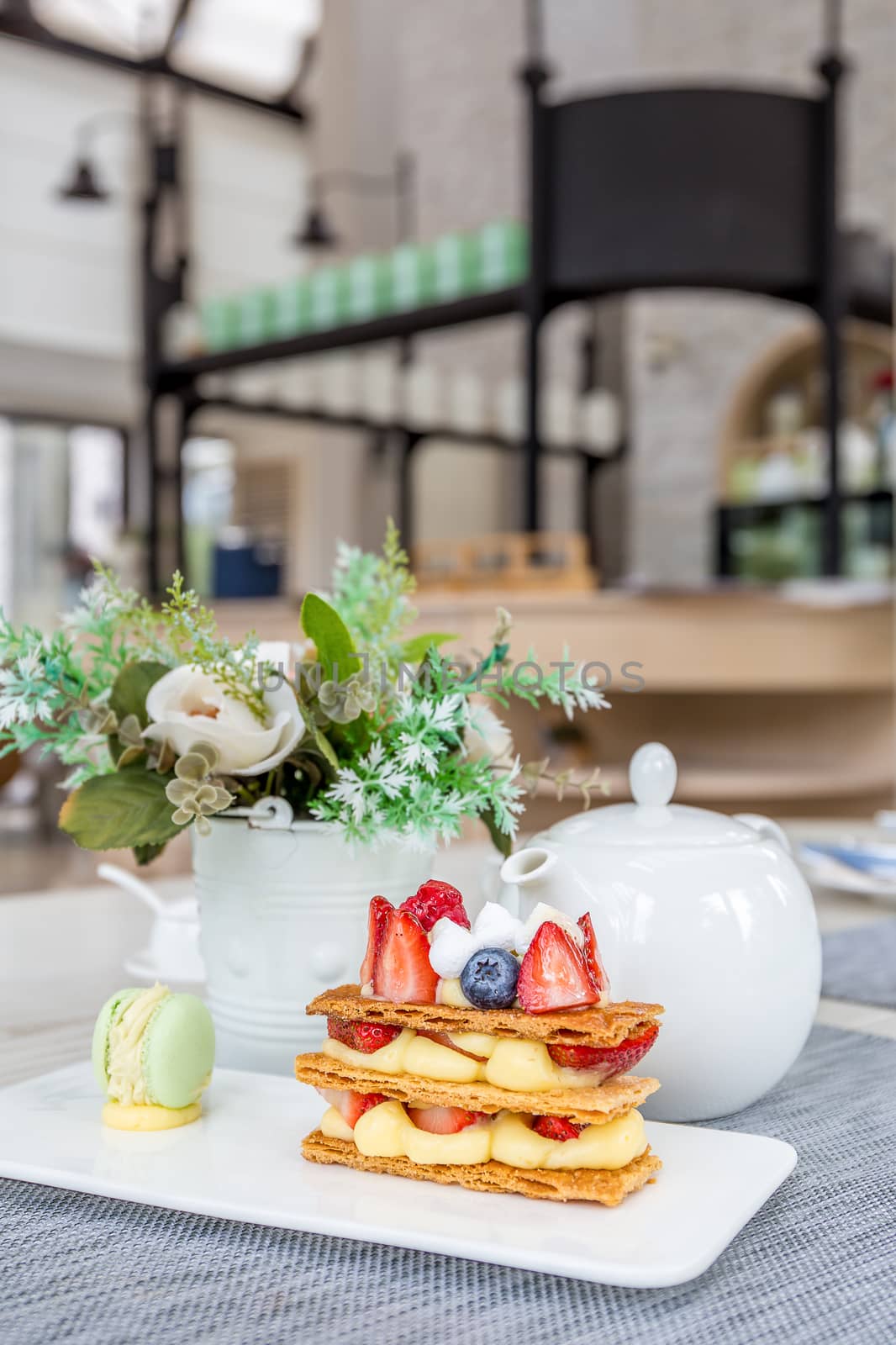 Mille Feuille with tea set on table in cafe.