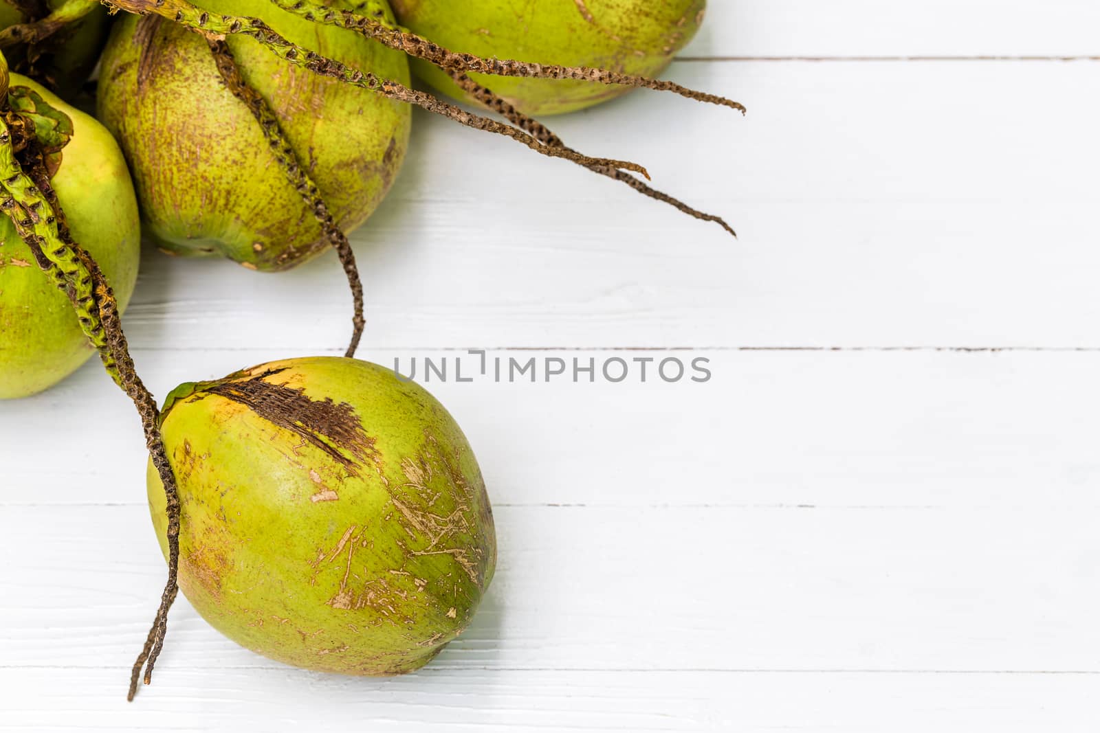 Green fresh coconut with bunch on white background.