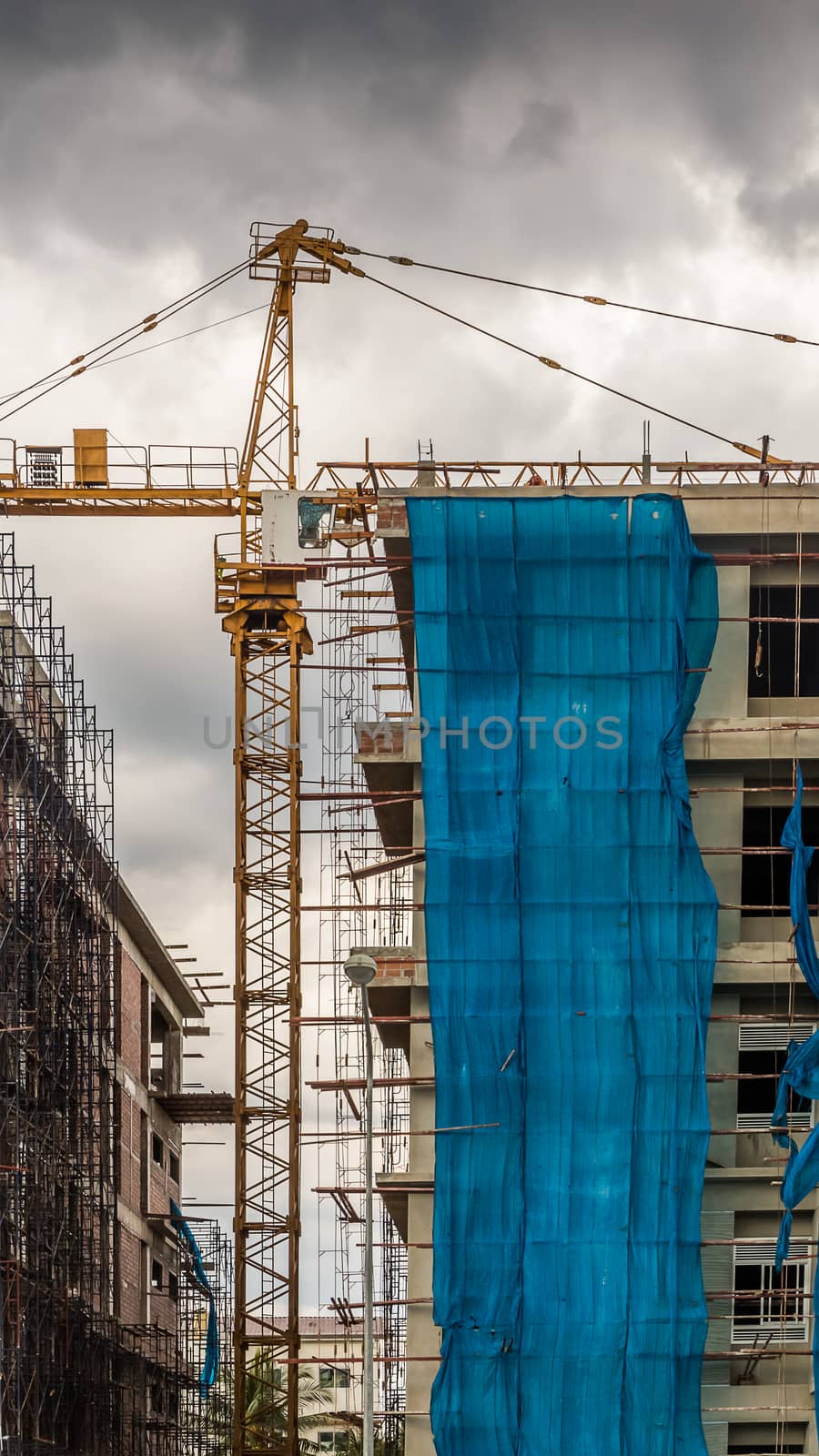 Crane at construction site building tall buildings.