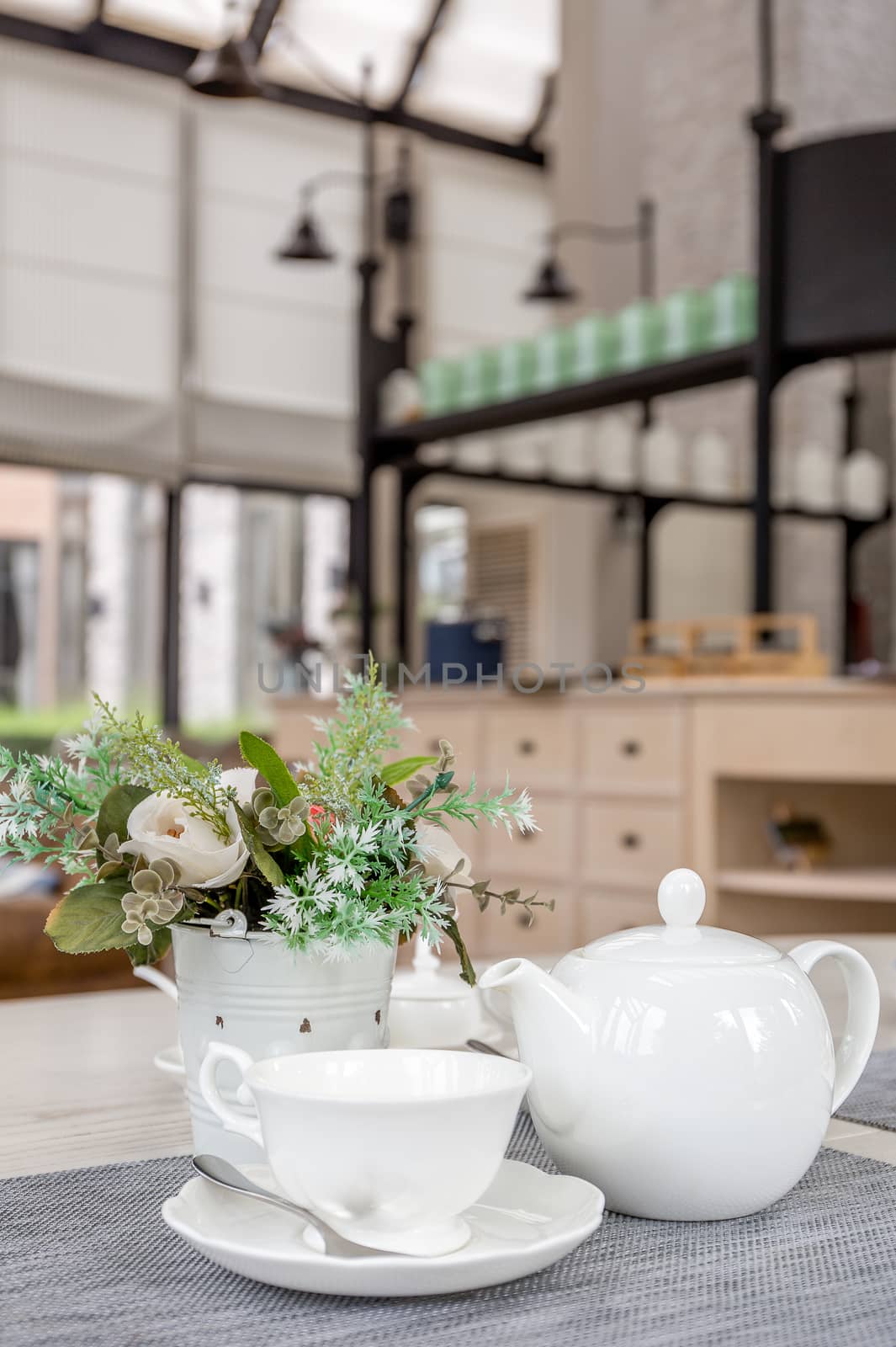 White English tea set on table in cafe.
