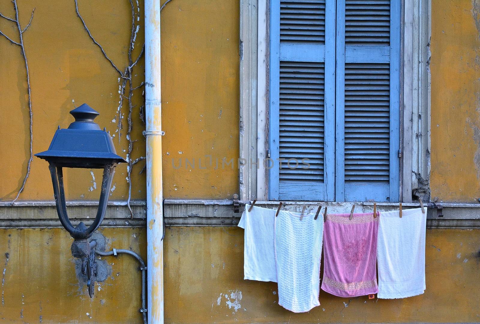 Wet clothes with clothespins on the rope at outdoors.