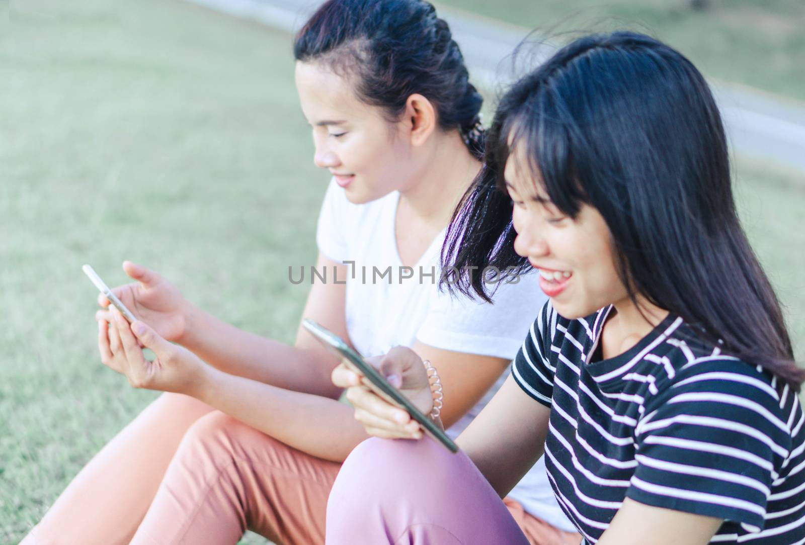 Closeup woman hand playing smartphone mobile with relaxing feelling, selective focus