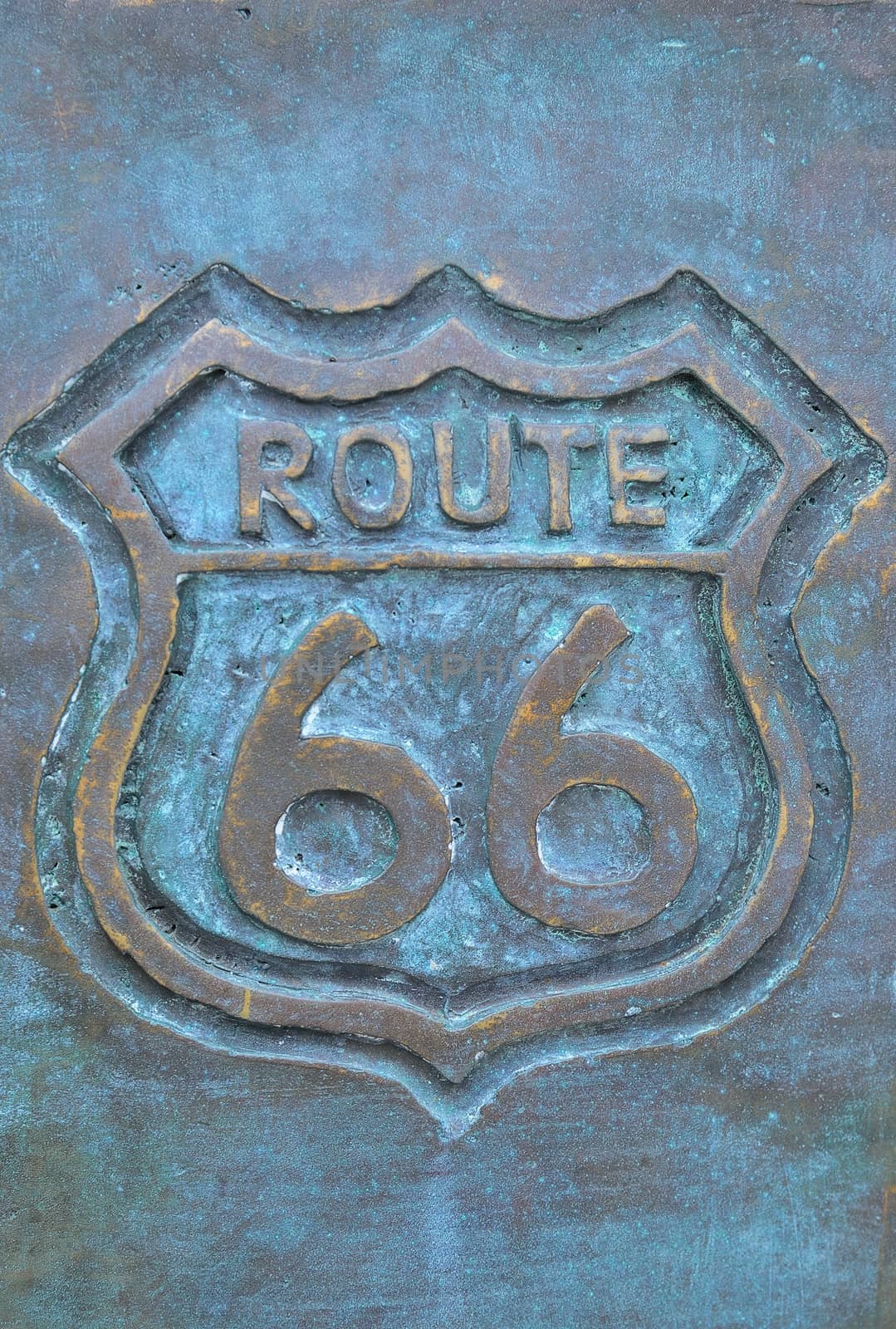 Old route 66 sign in bronze with green color.