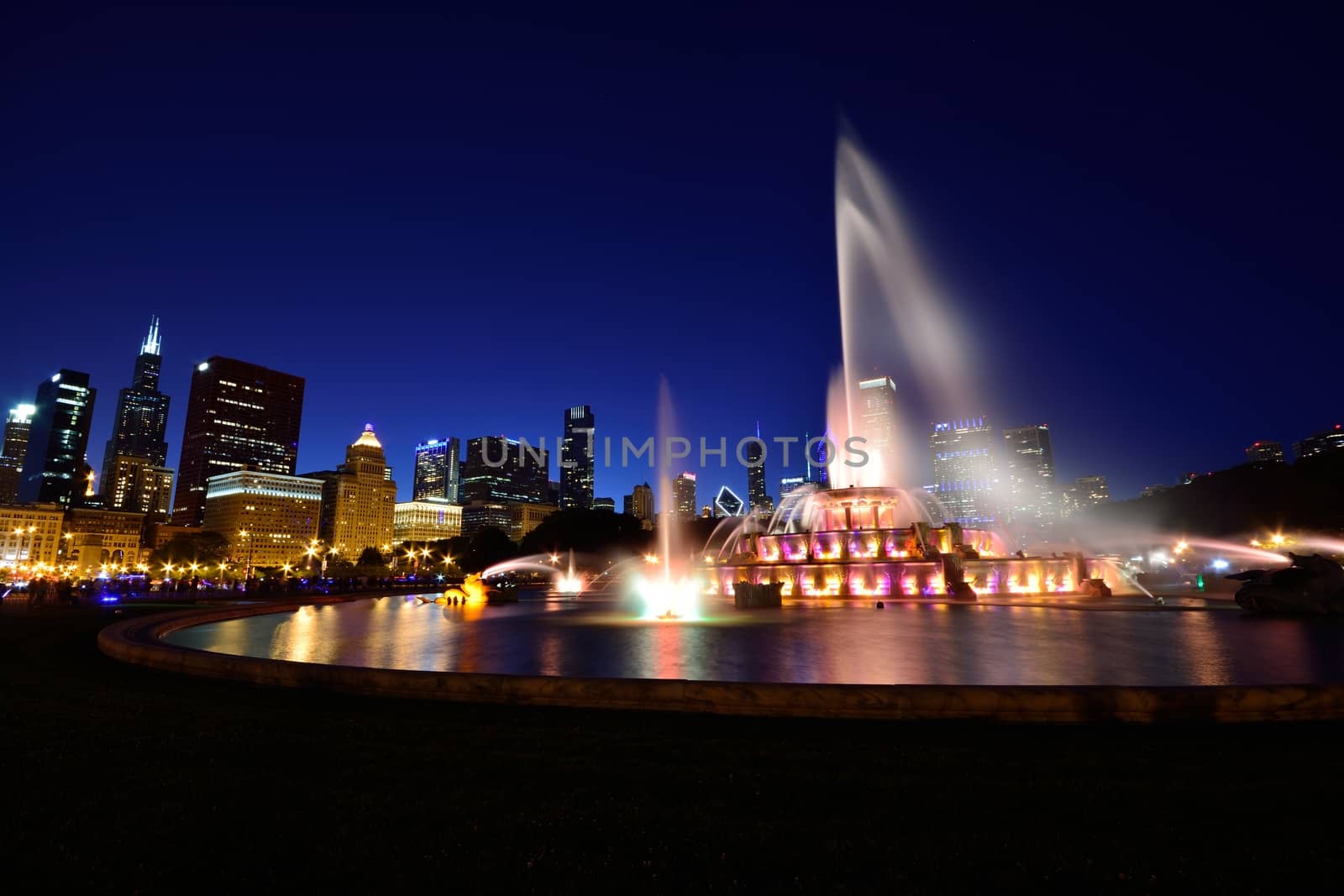 Chicago skyline panorama with skyscrapers and Buckingham fountain at night.