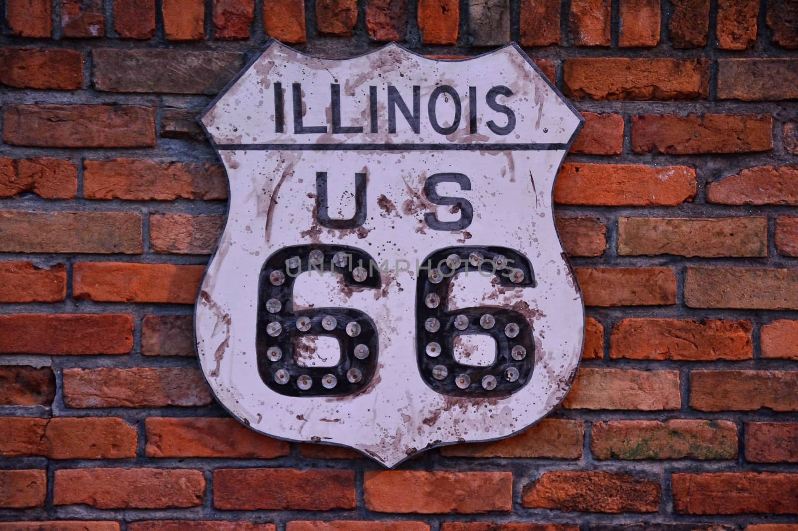 Historic Route 66 road sign painted on a brick wall in Illinois