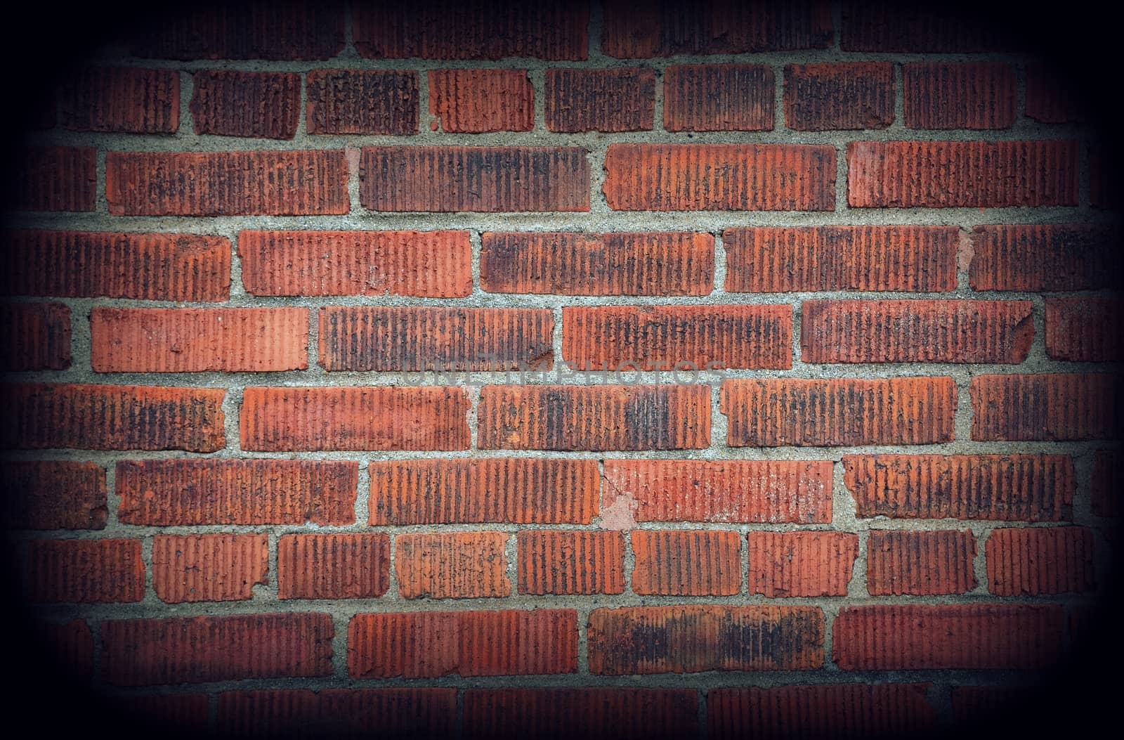 Red brick wall texture background with vignetting corners