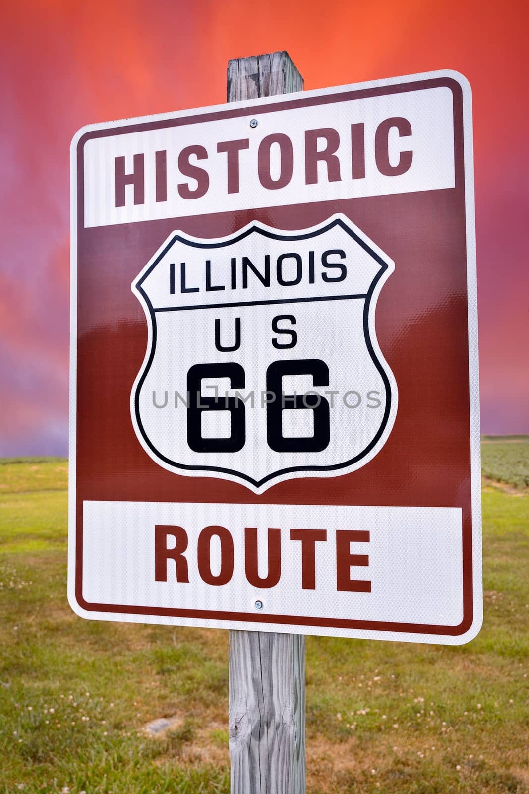 Historic Illinois Route 66 brown sign with sunset.