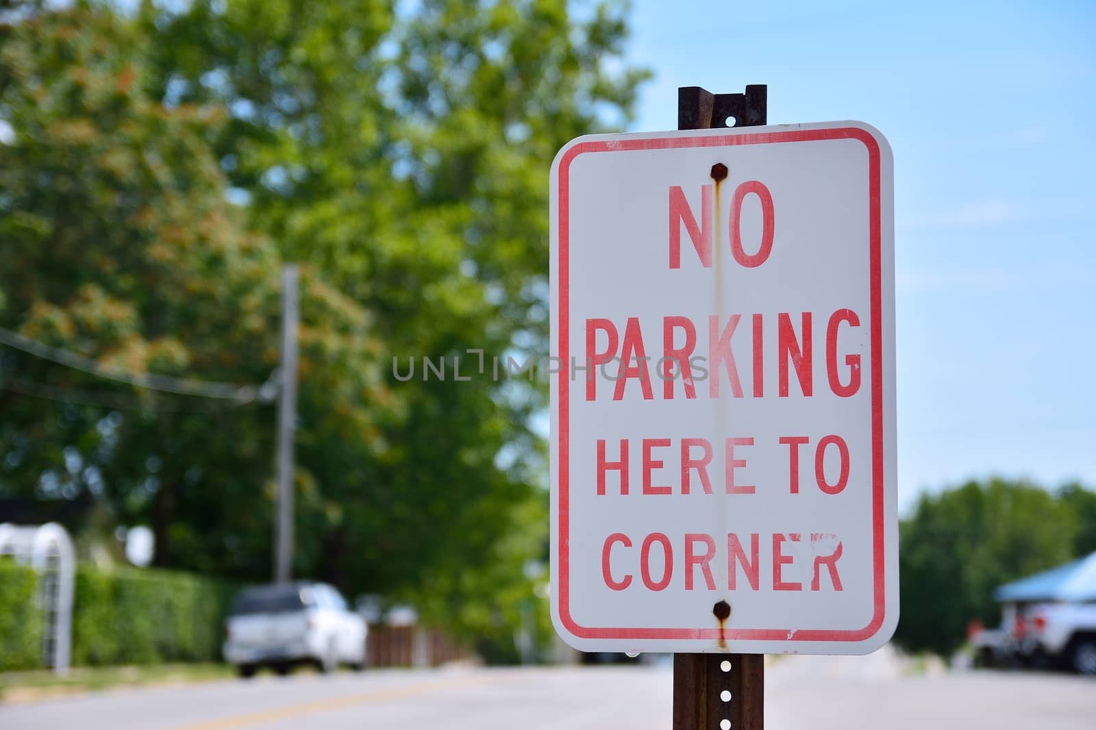 No parking here to corner sign in city.