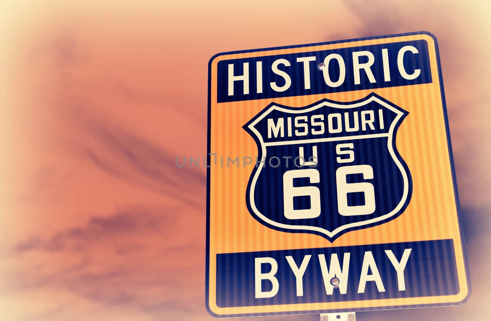 Historic route 66 highway sign in Missouri USA. Red sky background