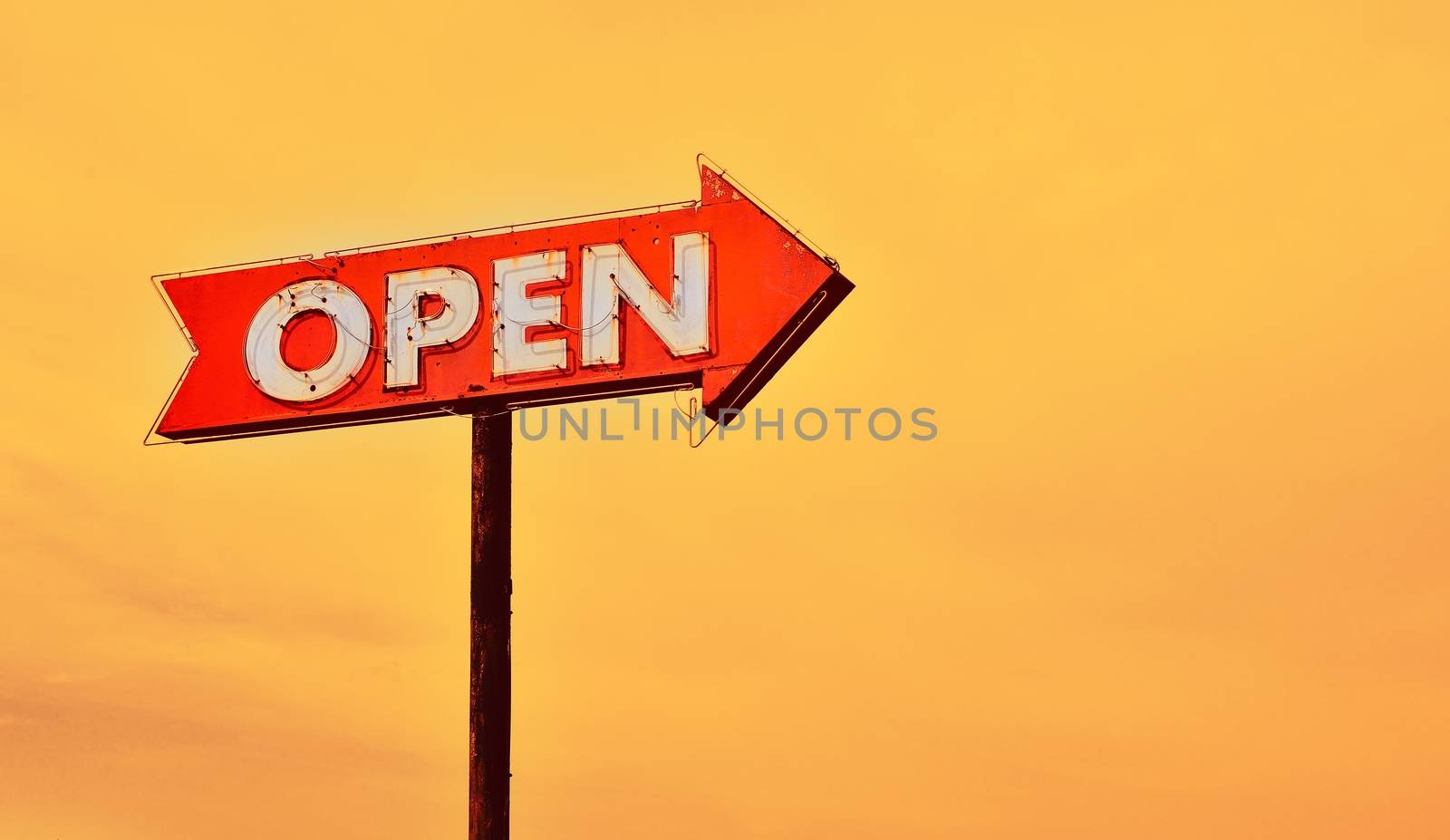 Open neon old sign in route 66 at sunset