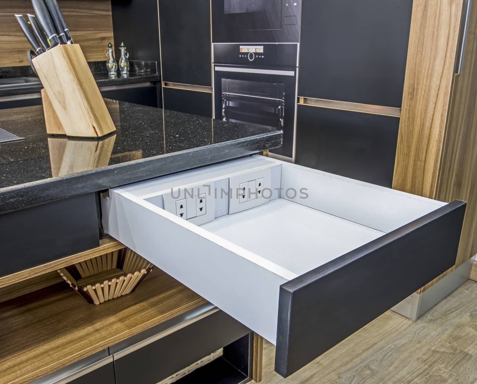 Interior design decor showing modern kitchen with sliding drawer and electric sockets in luxury apartment showroom