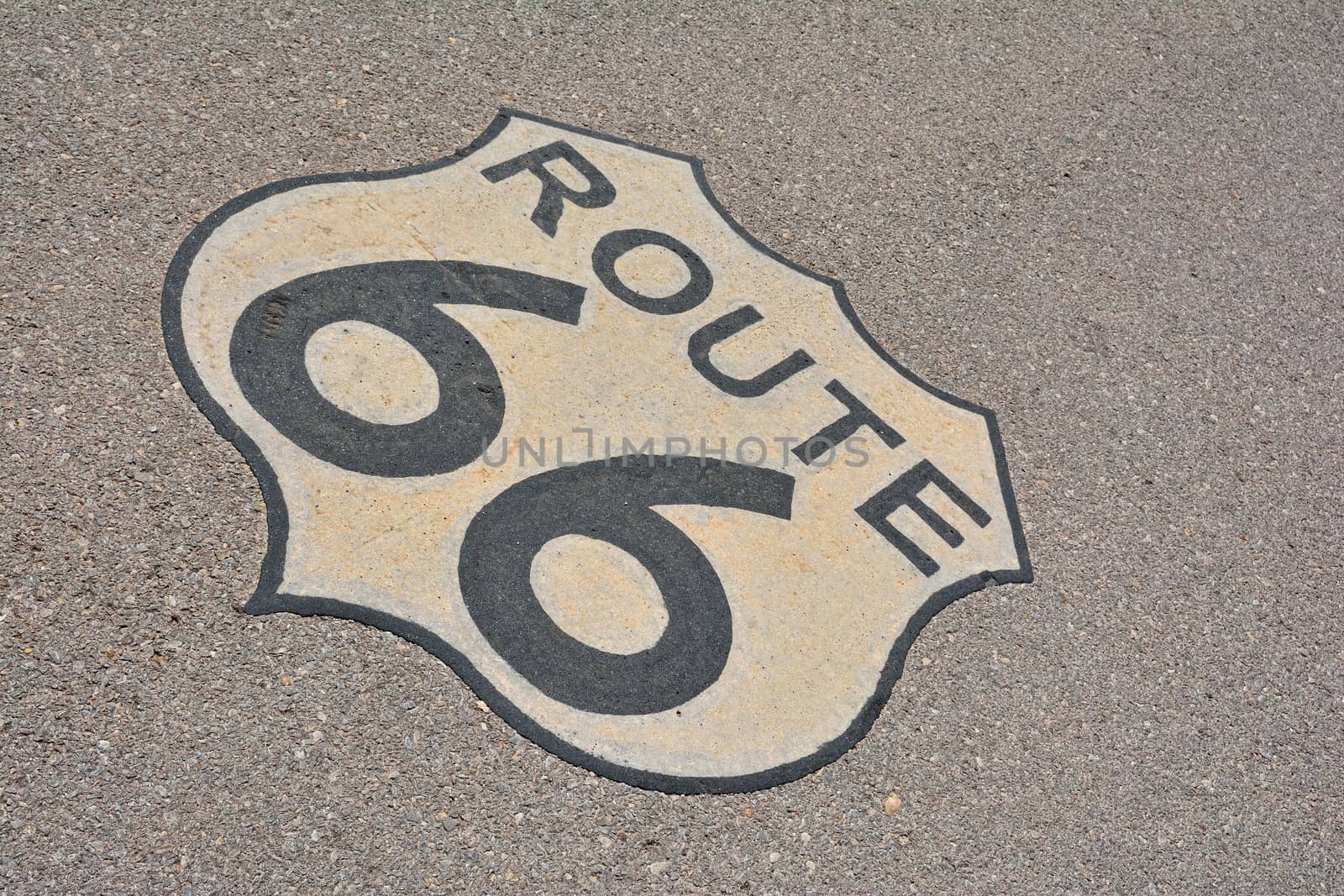 The mythical Route 66 sign, in road asphalt, USA.
