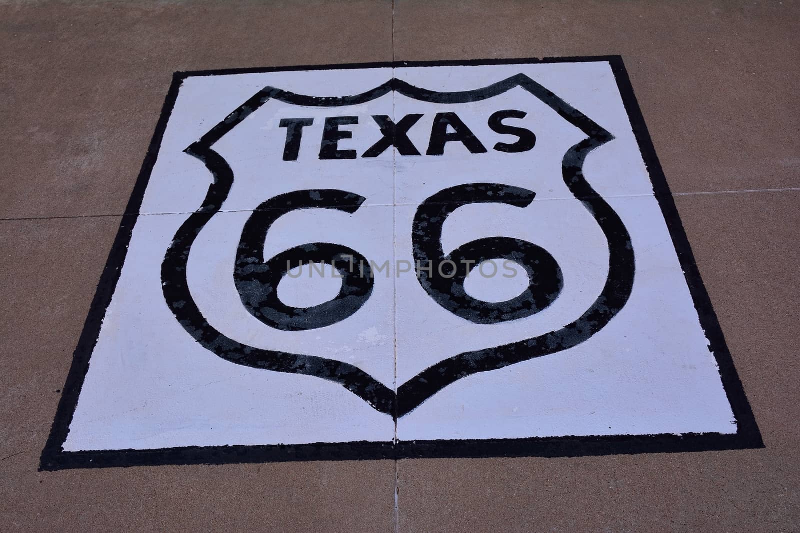 Historic Route 66 sign on the asphalt in Texas.