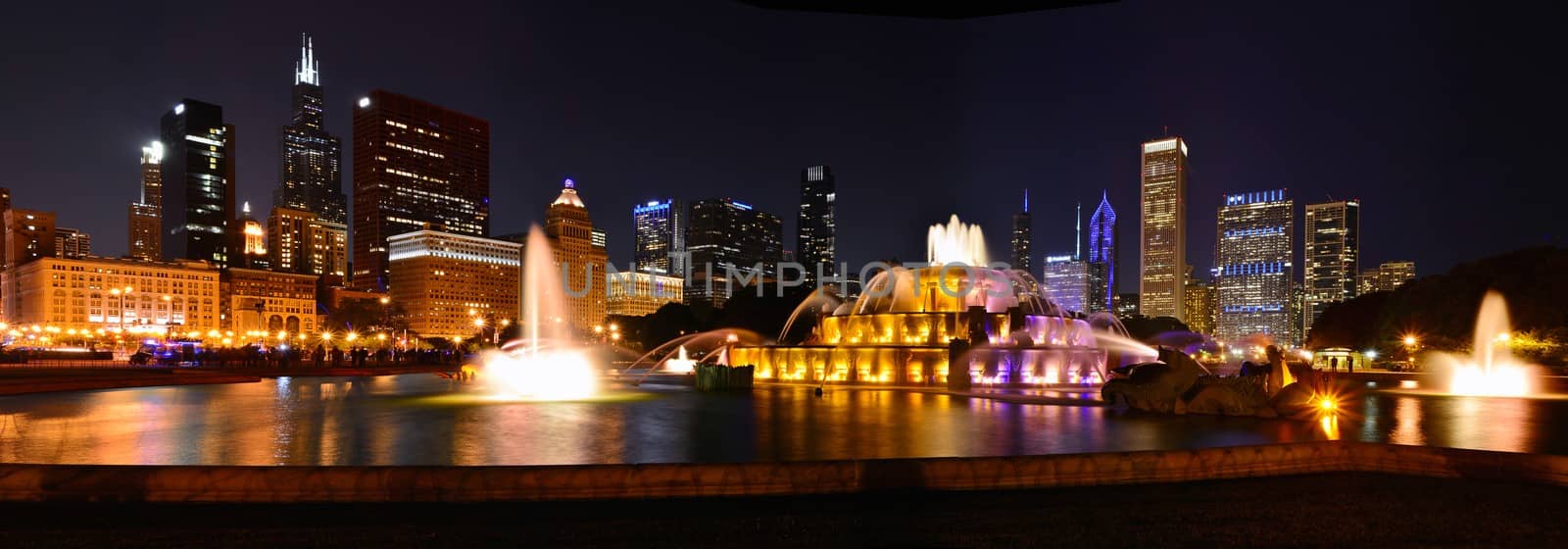 Chicago skyline panorama with skyscrapers and Buckingham fountain at night.