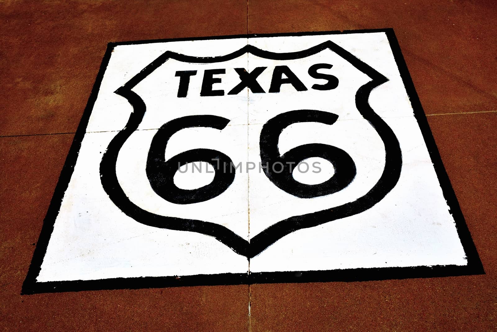 Historic Route 66 sign on the asphalt in Texas.