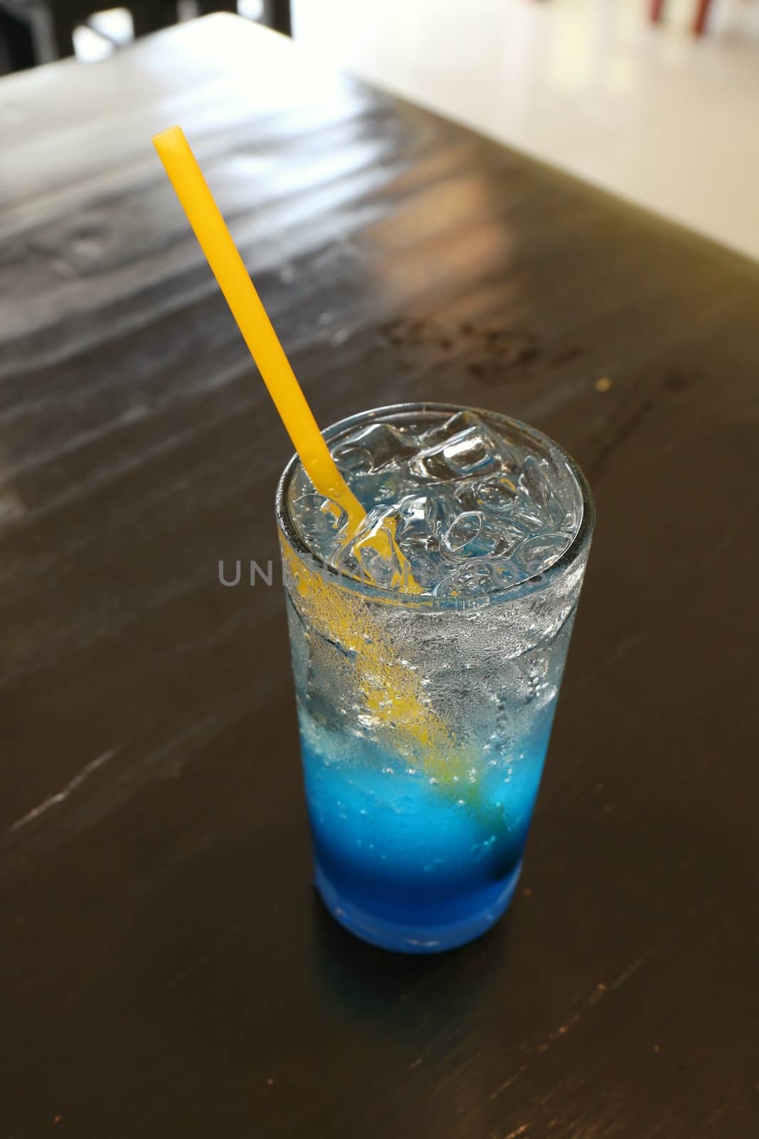 Glass cool ice water blue lemon juice on table for drink fresh by cgdeaw