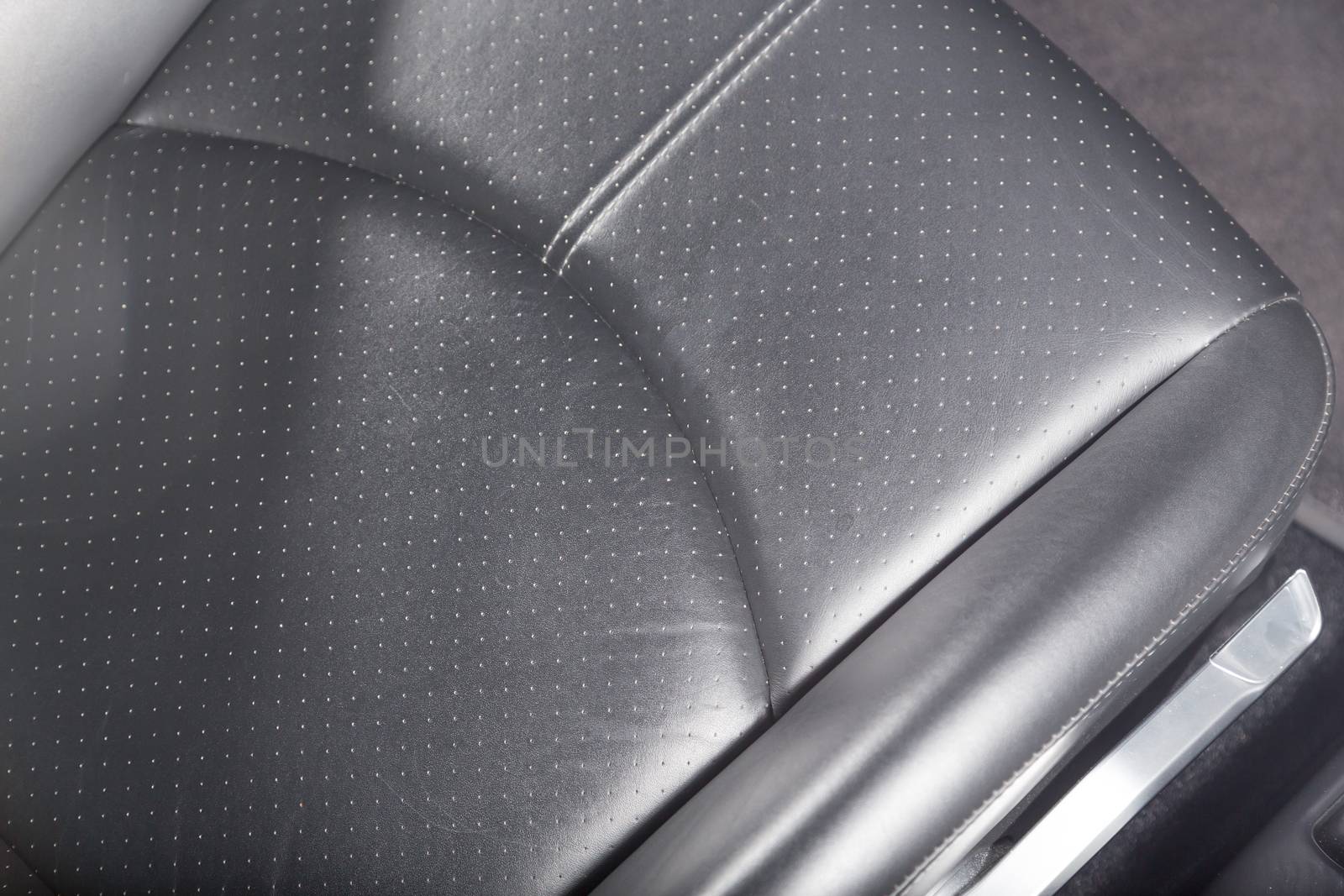 Close up of black leather car seat