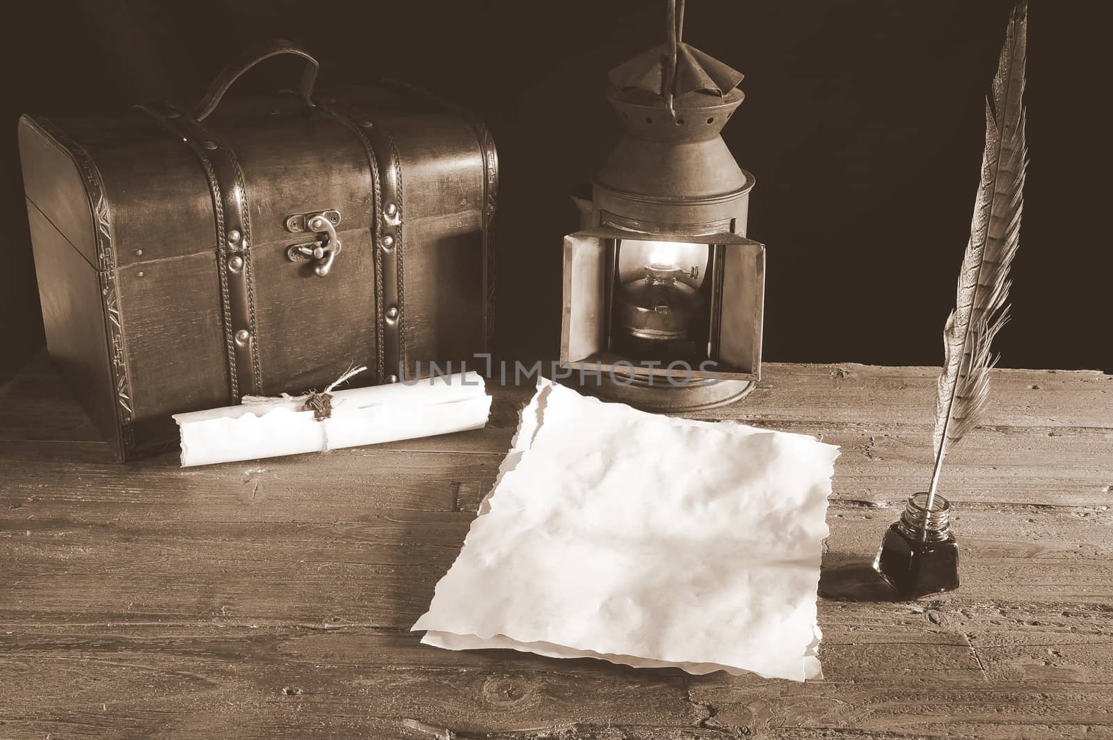 Work desk with parchment, inkwell and pen.